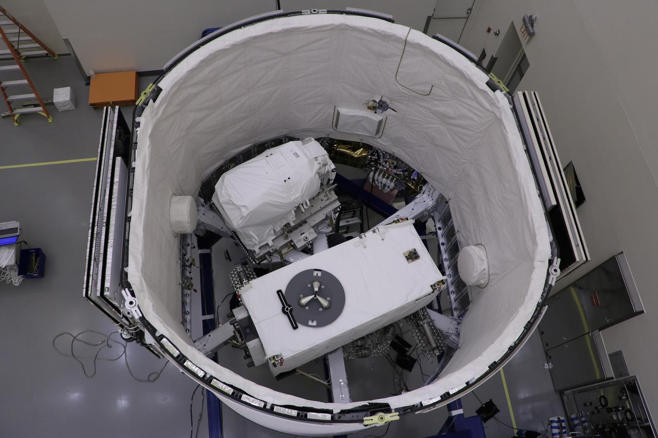 The ECOsystem Spaceborne Thermal Radiometer Experiment on Space Station (ECOSTRESS), pictured at the bottom, and the Latching End Effector (LEE), pictured at the top, are integrated into the unpressurized SpaceX Dragon truck June 2, 2018, at the SpaceX facility on Cape Canaveral Air Force Station in Florida. The payloads will be carried to the International Space Station on SpaceX's 15th Commercial Resupply Services mission. ECOSTRESS will measure the temperature of plants and use that information to better understand how much water plants need and how they respond to stress. The Canadian Space Agency is supplying LEE for the Canadarm2 as a spare to replace a failed unit removed by astronauts during a spacewalk in 2017. Each end of the Canadarm2 robotic arm has an identical LEE, which acts like a "hand" to grapple payloads and visiting cargo spaceships.