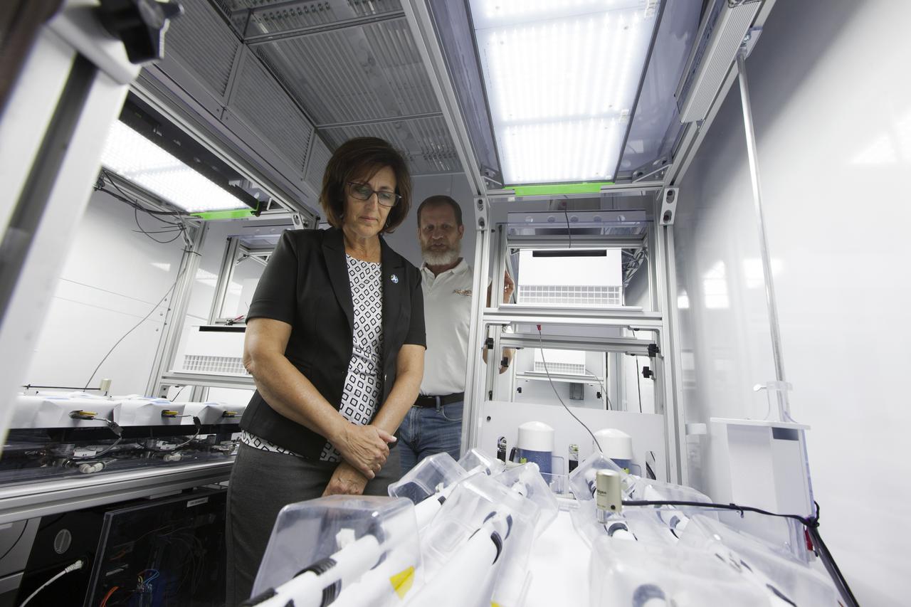Robyn Gatens, left, deputy director, ISS Division and system capability leader for Environmental Control and Life Support Systems (ECLSS) at NASA Headquarters in Washington, tours laboratories in the Space Station Processing Facility at the agency's Kennedy Space Center in Florida, on June 13, 2018. Standing behind her is Ralph Fritsche, long-duration food production project manager at Kennedy. Gatens is viewing plant growth chambers and seeing firsthand some of the capabilities in the center's Exploration Research and Technology Programs.