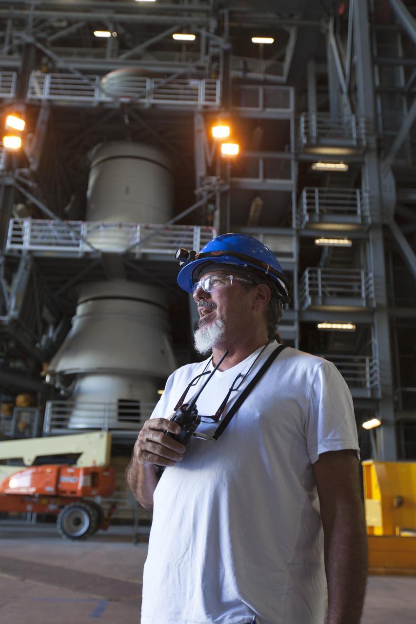Inside the Vehicle Assembly Building at NASA's Kennedy Space Center in Florida, Anthony Sabatino, with Jacobs on the Test and Operations Support Contract, awaits arrival of the first of three aeroshells for Orion's Launch Abort System (LAS) on June 19, 2018. The aeroshell is arriving by truck from EMF Inc. on nearby Merritt Island and will be offloaded and secured in High Bay 4. The aeroshells will be stacked and prepared for a full-stress test of the LAS, called Ascent Abort-2 (AA-2) flight test, scheduled for April 2019. During the test, a booster will launch from Space Launch Complex 46 at Cape Canaveral Air Force Station, carrying a fully functional LAS and a 22,000-pound Orion test vehicle to an altitude of 31,000 feet and traveling at more than 1,000 miles an hour. The test will verify the LAS can steer the crew module and astronauts aboard to safety in the event of an issue with the Space Launch System (SLS) rocket when the spacecraft is under the highest aerodynamic loads it will experience during a rapid climb into space. Orion is being prepared for its first integrated uncrewed flight atop the SLS on Exploration Mission-1.