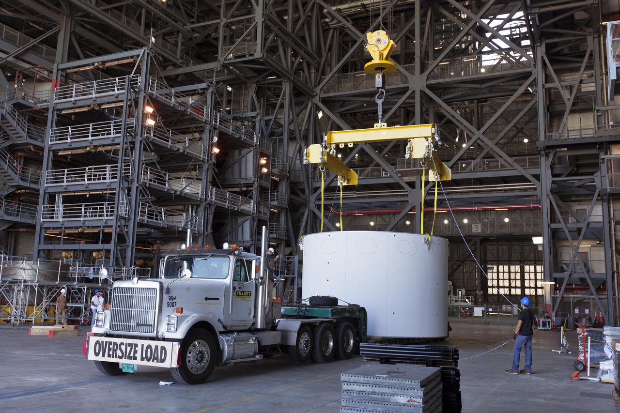 The first of three aeroshells for Orion's Launch Abort System (LAS) arrives by truck in High Bay 4 inside the Vehicle Assembly Building at NASA's Kennedy Space Center in Florida, on June 19, 2018. The aeroshell was shipped from EMF Inc. on nearby Merritt Island. The aeroshells will be stacked and prepared for a full-stress test of the LAS, called Ascent Abort-2 (AA-2) flight test, scheduled for April 2019. During the test, a booster will launch from Space Launch Complex 46 at Cape Canaveral Air Force Station, carrying a fully functional LAS and a 22,000-pound Orion test vehicle to an altitude of 31,000 feet and traveling at more than 1,000 miles an hour. The test will verify the LAS can steer the crew module and astronauts aboard to safety in the event of an issue with the Space Launch System (SLS) rocket when the spacecraft is under the highest aerodynamic loads it will experience during a rapid climb into space. Orion is being prepared for its first integrated uncrewed flight atop the SLS on Exploration Mission-1.