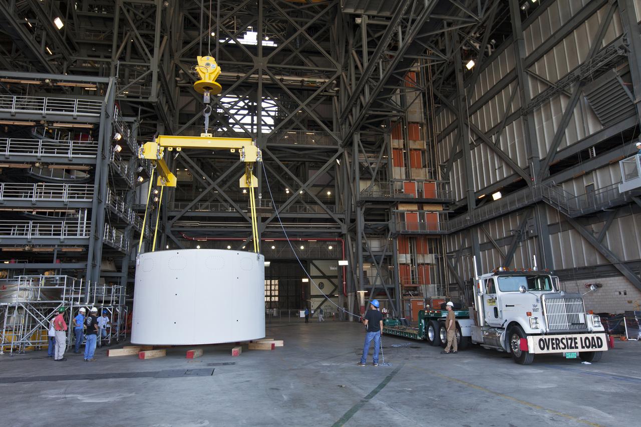 The first of three aeroshells for Orion's Launch Abort System (LAS) is offloaded from its transport truck by crane in High Bay 4 inside the Vehicle Assembly Building at NASA's Kennedy Space Center in Florida, on June 19, 2018. The aeroshell was shipped from EMF Inc. on nearby Merritt Island. The aeroshells will be stacked and prepared for a full-stress test of the LAS, called Ascent Abort-2 (AA-2) flight test, scheduled for April 2019. During the test, a booster will launch from Space Launch Complex 46 at Cape Canaveral Air Force Station, carrying a fully functional LAS and a 22,000-pound Orion test vehicle to an altitude of 31,000 feet and traveling at more than 1,000 miles an hour. The test will verify the LAS can steer the crew module and astronauts aboard to safety in the event of an issue with the Space Launch System (SLS) rocket when the spacecraft is under the highest aerodynamic loads it will experience during a rapid climb into space. Orion is being prepared for its first integrated uncrewed flight atop the SLS on Exploration Mission-1.
