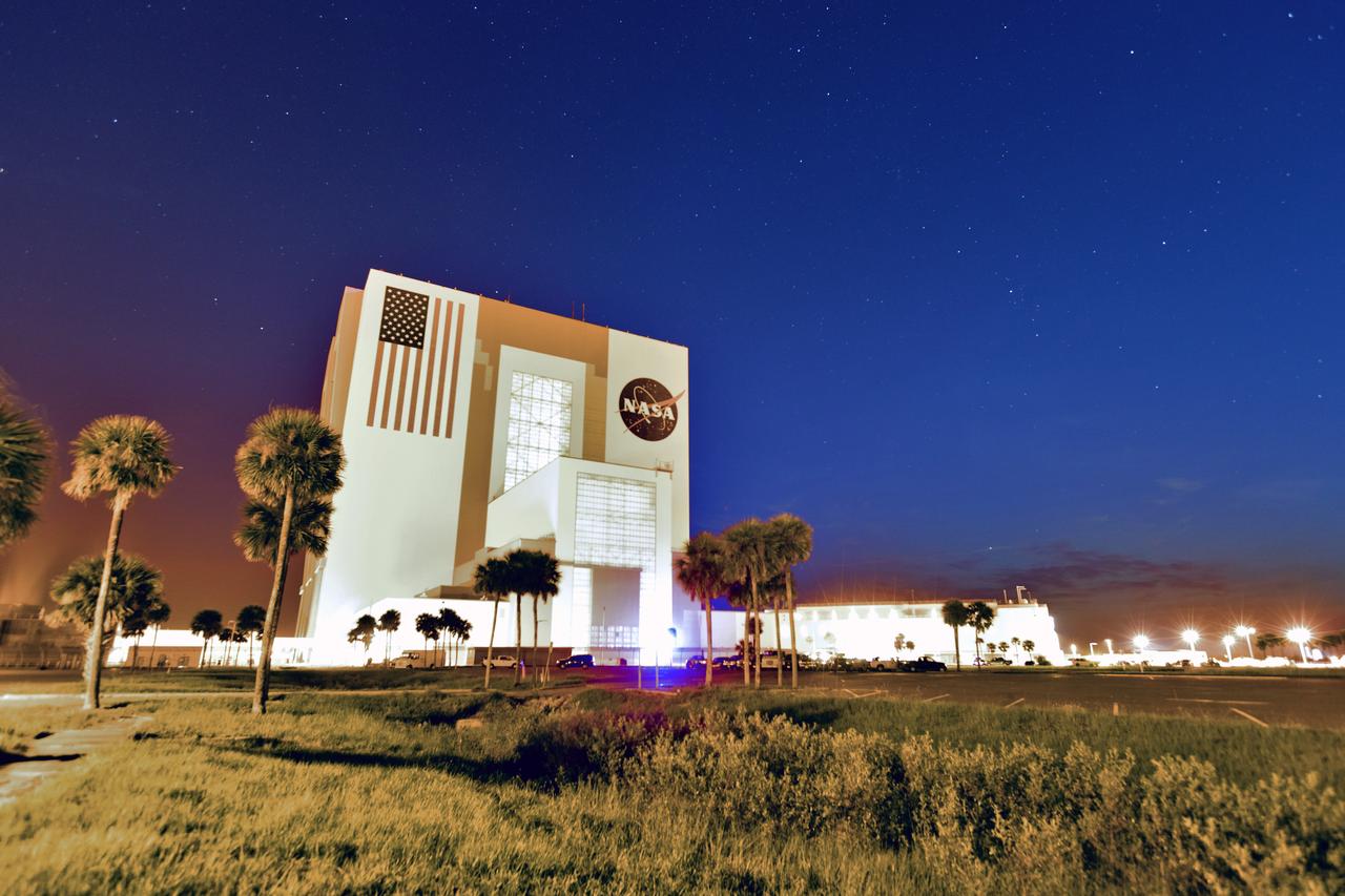 A sunrise creative view of the iconic Vehicle Assembly Building (VAB) and Launch Control Center at NASA's Kennedy Space Center in Florida. Ten levels of work platforms have been installed in High Bay 3 of the VAB. They will surround and provide access for service and processing of NASA's Space Launch System (SLS) rocket and Orion spacecraft. Exploration Ground Systems oversaw the upgrades and installation of the new work platforms to support the launch of the SLS and Orion on Exploration Mission-1 and deep space missions.