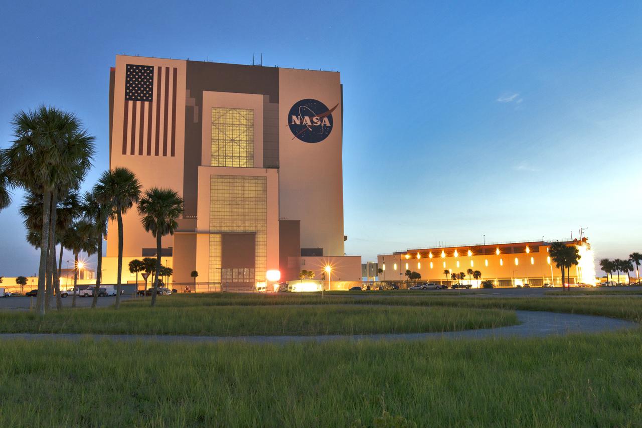 A sunrise panoramic view of the iconic Vehicle Assembly Building (VAB) and Launch Control Center at NASA's Kennedy Space Center in Florida. Ten levels of work platforms have been installed in High Bay 3 of the VAB. They will surround and provide access for service and processing of NASA's Space Launch System (SLS) rocket and Orion spacecraft. Exploration Ground Systems oversaw the upgrades and installation of the new work platforms to support the launch of the SLS and Orion on Exploration Mission-1 and deep space missions.