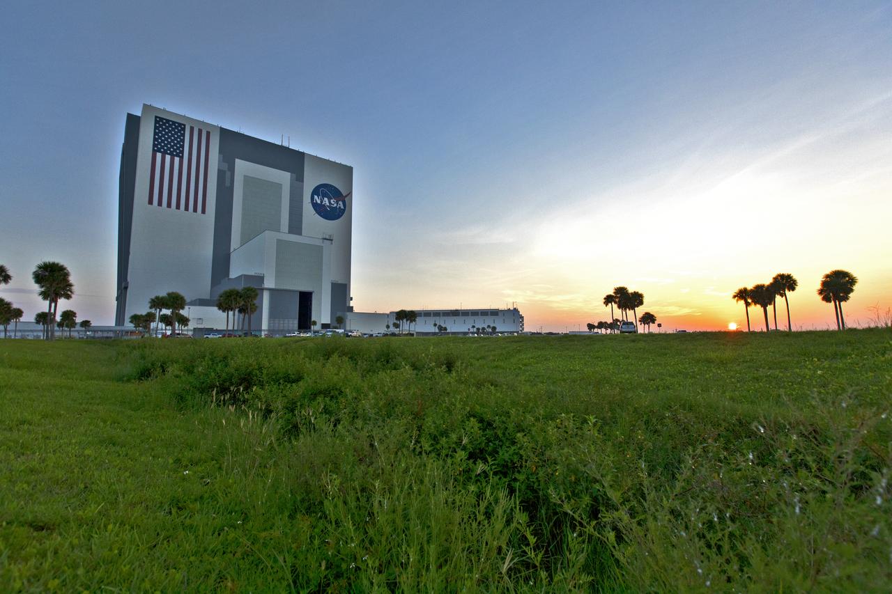 A sunrise panoramic view of the iconic Vehicle Assembly Building (VAB) and Launch Control Center at NASA's Kennedy Space Center in Florida. Ten levels of work platforms have been installed in High Bay 3 of the VAB. They will surround and provide access for service and processing of NASA's Space Launch System (SLS) rocket and Orion spacecraft. Exploration Ground Systems oversaw the upgrades and installation of the new work platforms to support the launch of the SLS and Orion on Exploration Mission-1 and deep space missions.