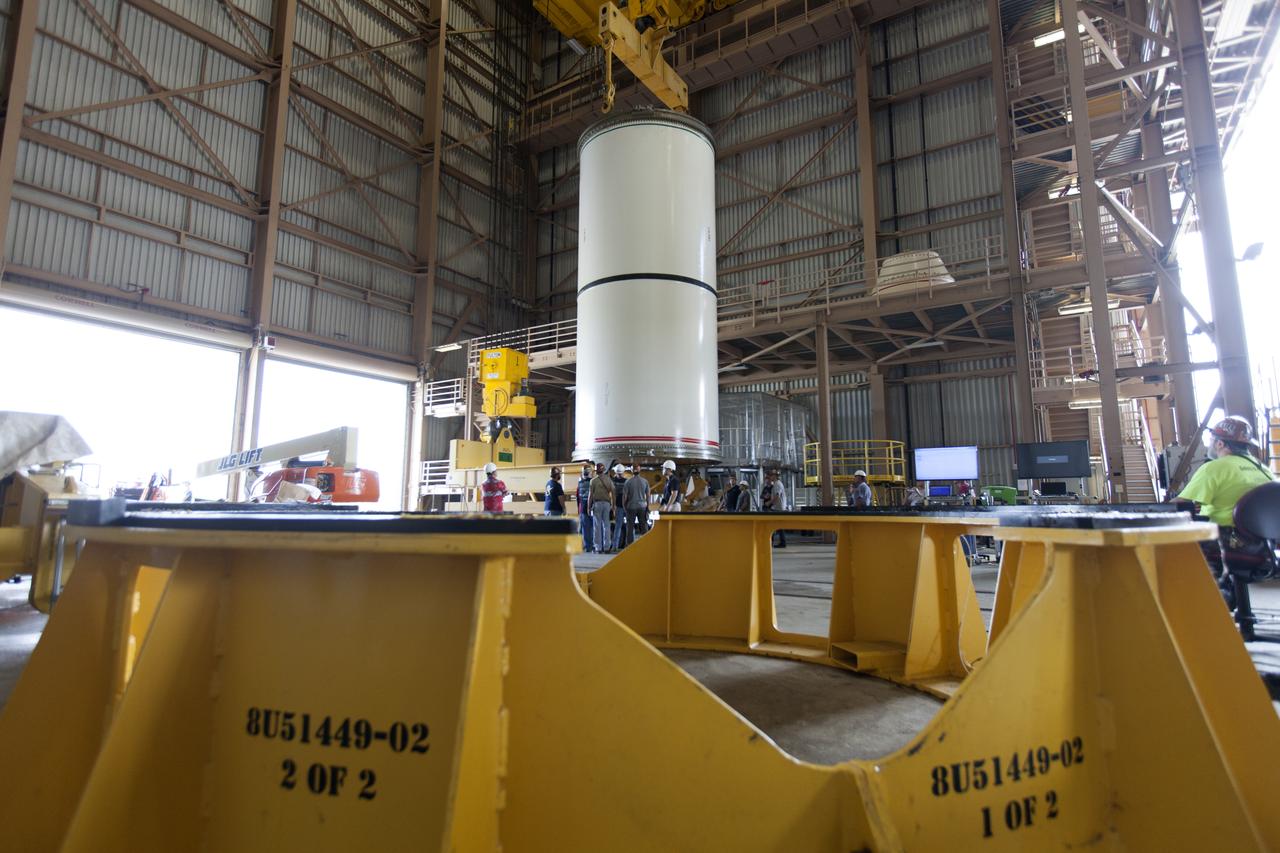 Jacobs technicians, on the Test and Operations Support Contract, practice crane operations with an inert booster rocket segment in the Rotation, Processing and Surge Facility on June 22, 2018, at NASA's Kennedy Space Center in Florida. Dual cranes are being used to move the segment from vertical to horizontal, a maneuver known as a "breakover rotation." As part of routine processing operations for the agency's Space Launch System (SLS) rocket, the RPSF team will receive all of the solid rocket fuel segments for inspection and preparation prior to transporting them to the Vehicle Assembly Building for stacking on the mobile launcher. Many pathfinding operations are being done to prepare for launch of the SLS and Orion spacecraft on Exploration Mission-1 and deep space missions.
