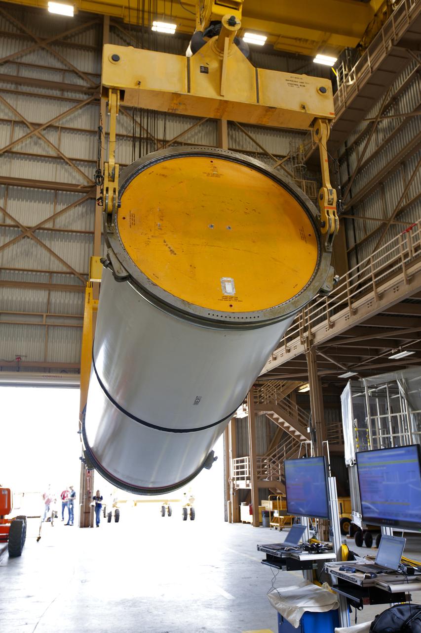 Jacobs technicians, on the Test and Operations Support Contract, practice crane operations with an inert booster rocket segment in the Rotation, Processing and Surge Facility on June 22, 2018, at NASA's Kennedy Space Center in Florida. Dual cranes are used to move the segment from vertical to horizontal, a maneuver known as a "breakover rotation." As part of routine processing operations for the agency's Space Launch System (SLS) rocket, the RPSF team will receive all of the solid rocket fuel segments for inspection and preparation prior to transporting them to the Vehicle Assembly Building for stacking on the mobile launcher. Many pathfinding operations are being done to prepare for launch of the SLS and Orion spacecraft on Exploration Mission-1 and deep space missions.