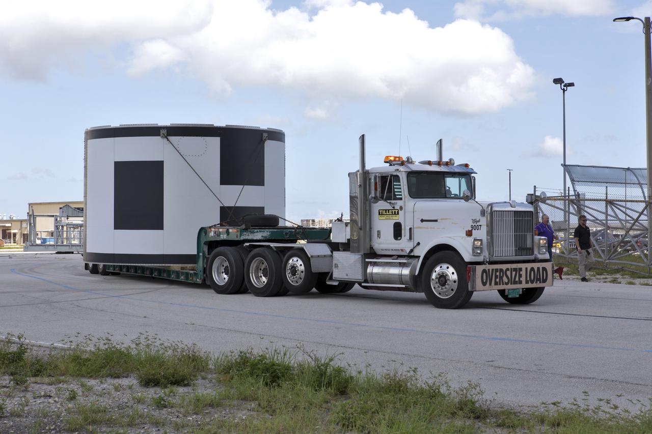 The second of three aeroshells for Orion's Launch Abort System (LAS) arrives by truck at the Vehicle Assembly Building at NASA's Kennedy Space Center in Florida, on June 26, 2018. The aeroshell was shipped from EMF Inc. on nearby Merritt Island. It will be offloaded and secured in High Bay 4. The aeroshells will be stacked and prepared for a full-stress test of the LAS, called Ascent Abort-2 (AA-2) flight test, scheduled for April 2019. During the test, a booster will launch from Space Launch Complex 46 at Cape Canaveral Air Force Station, carrying a fully functional LAS and a 22,000-pound Orion test vehicle to an altitude of 31,000 feet and traveling at more than 1,000 miles an hour. The test will verify the LAS can steer the crew module and astronauts aboard to safety in the event of an issue with the Space Launch System (SLS) rocket when the spacecraft is under the highest aerodynamic loads it will experience during a rapid climb into space. Orion is being prepared for its first integrated uncrewed flight atop the SLS on Exploration Mission-1.