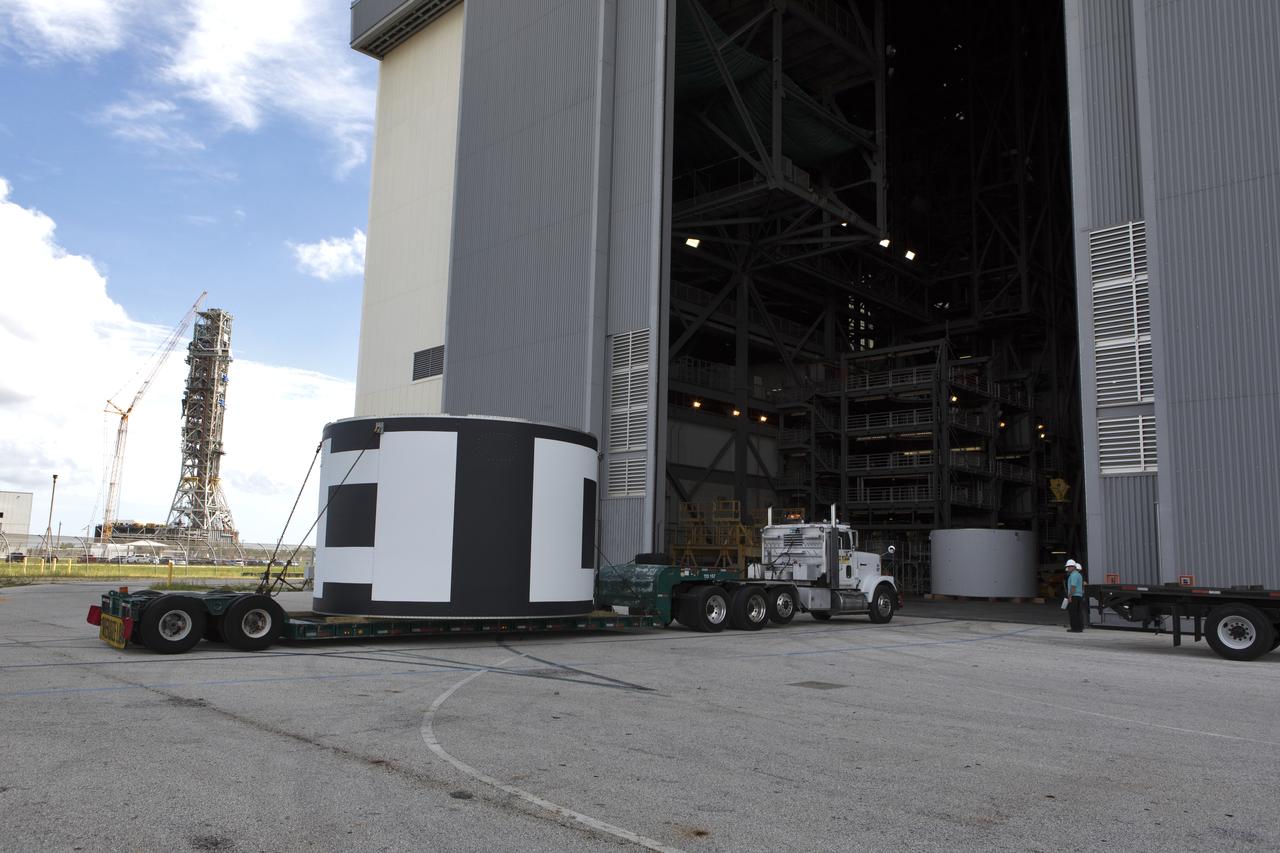 The second of three aeroshells for Orion's Launch Abort System (LAS) arrives by truck at the Vehicle Assembly Building at NASA's Kennedy Space Center in Florida, on June 26, 2018. The aeroshell was shipped from EMF Inc. on nearby Merritt Island. It will be offloaded and secured in High Bay 4. The aeroshells will be stacked and prepared for a full-stress test of the LAS, called Ascent Abort-2 (AA-2) flight test, scheduled for April 2019. During the test, a booster will launch from Space Launch Complex 46 at Cape Canaveral Air Force Station, carrying a fully functional LAS and a 22,000-pound Orion test vehicle to an altitude of 31,000 feet and traveling at more than 1,000 miles an hour. The test will verify the LAS can steer the crew module and astronauts aboard to safety in the event of an issue with the Space Launch System (SLS) rocket when the spacecraft is under the highest aerodynamic loads it will experience during a rapid climb into space. Orion is being prepared for its first integrated uncrewed flight atop the SLS on Exploration Mission-1.