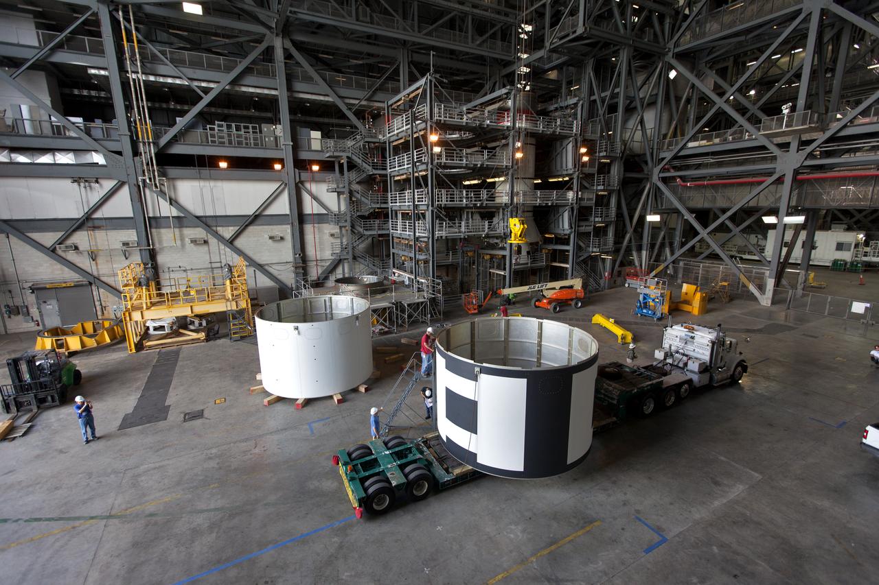 The second of three aeroshells, at right, for Orion's Launch Abort System (LAS) arrives by flatbed truck in High Bay 4 of the Vehicle Assembly Building at NASA's Kennedy Space Center in Florida, on June 26, 2018. The aeroshell was shipped from EMF Inc. on nearby Merritt Island. It will be offloaded and secured in the high bay. The aeroshells will be stacked and prepared for a full-stress test of the LAS, called Ascent Abort-2 (AA-2) flight test, scheduled for April 2019. During the test, a booster will launch from Space Launch Complex 46 at Cape Canaveral Air Force Station, carrying a fully functional LAS and a 22,000-pound Orion test vehicle to an altitude of 31,000 feet and traveling at more than 1,000 miles an hour. The test will verify the LAS can steer the crew module and astronauts aboard to safety in the event of an issue with the Space Launch System (SLS) rocket when the spacecraft is under the highest aerodynamic loads it will experience during a rapid climb into space. Orion is being prepared for its first integrated uncrewed flight atop the SLS on Exploration Mission-1.