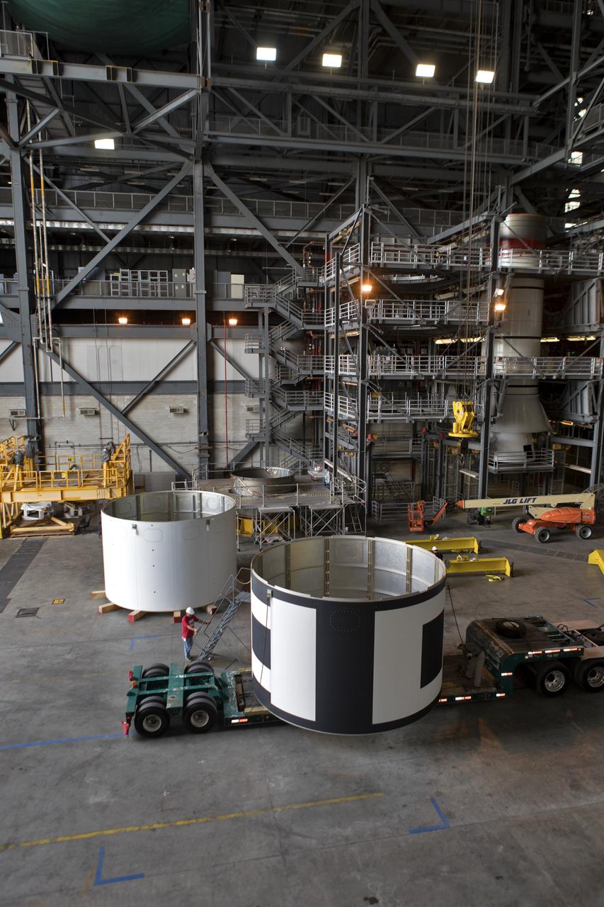 The second of three aeroshells, at right, for Orion's Launch Abort System (LAS) arrives by flatbed truck in High Bay 4 of the Vehicle Assembly Building at NASA's Kennedy Space Center in Florida, on June 26, 2018. The aeroshell was shipped from EMF Inc. on nearby Merritt Island. It will be offloaded and secured in the high bay. The aeroshells will be stacked and prepared for a full-stress test of the LAS, called Ascent Abort-2 (AA-2) flight test, scheduled for April 2019. During the test, a booster will launch from Space Launch Complex 46 at Cape Canaveral Air Force Station, carrying a fully functional LAS and a 22,000-pound Orion test vehicle to an altitude of 31,000 feet and traveling at more than 1,000 miles an hour. The test will verify the LAS can steer the crew module and astronauts aboard to safety in the event of an issue with the Space Launch System (SLS) rocket when the spacecraft is under the highest aerodynamic loads it will experience during a rapid climb into space. Orion is being prepared for its first integrated uncrewed flight atop the SLS on Exploration Mission-1.