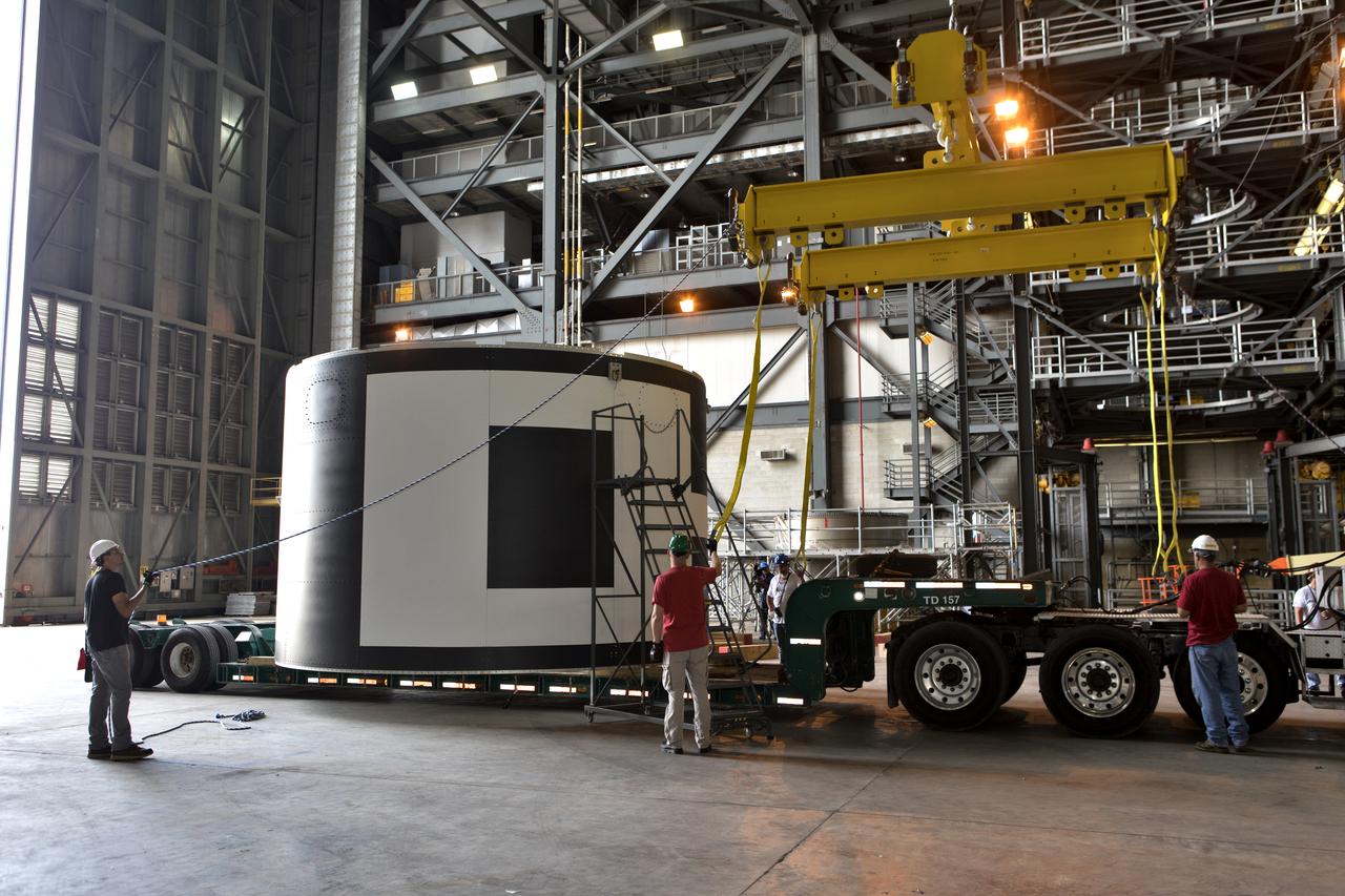 The second of three aeroshells for Orion's Launch Abort System (LAS) arrives by flatbed truck in High Bay 4 of the Vehicle Assembly Building at NASA's Kennedy Space Center in Florida, on June 26, 2018. The aeroshell was shipped from EMF Inc. on nearby Merritt Island. It will be offloaded and secured in the high bay. The aeroshells will be stacked and prepared for a full-stress test of the LAS, called Ascent Abort-2 (AA-2) flight test, scheduled for April 2019. During the test, a booster will launch from Space Launch Complex 46 at Cape Canaveral Air Force Station, carrying a fully functional LAS and a 22,000-pound Orion test vehicle to an altitude of 31,000 feet and traveling at more than 1,000 miles an hour. The test will verify the LAS can steer the crew module and astronauts aboard to safety in the event of an issue with the Space Launch System (SLS) rocket when the spacecraft is under the highest aerodynamic loads it will experience during a rapid climb into space. Orion is being prepared for its first integrated uncrewed flight atop the SLS on Exploration Mission-1.