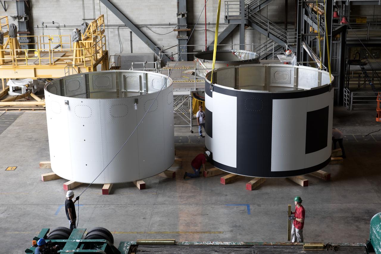 The second of three aeroshells, at right, for Orion's Launch Abort System (LAS) was lifted up from a flatbed truck and secured in High Bay 4 of the Vehicle Assembly Building at NASA's Kennedy Space Center in Florida, on June 26, 2018. The aeroshell was shipped from EMF Inc. on nearby Merritt Island. The aeroshells will be stacked and prepared for a full-stress test of the LAS, called Ascent Abort-2 (AA-2) flight test, scheduled for April 2019. During the test, a booster will launch from Space Launch Complex 46 at Cape Canaveral Air Force Station, carrying a fully functional LAS and a 22,000-pound Orion test vehicle to an altitude of 31,000 feet and traveling at more than 1,000 miles an hour. The test will verify the LAS can steer the crew module and astronauts aboard to safety in the event of an issue with the Space Launch System (SLS) rocket when the spacecraft is under the highest aerodynamic loads it will experience during a rapid climb into space. Orion is being prepared for its first integrated uncrewed flight atop the SLS on Exploration Mission-1.