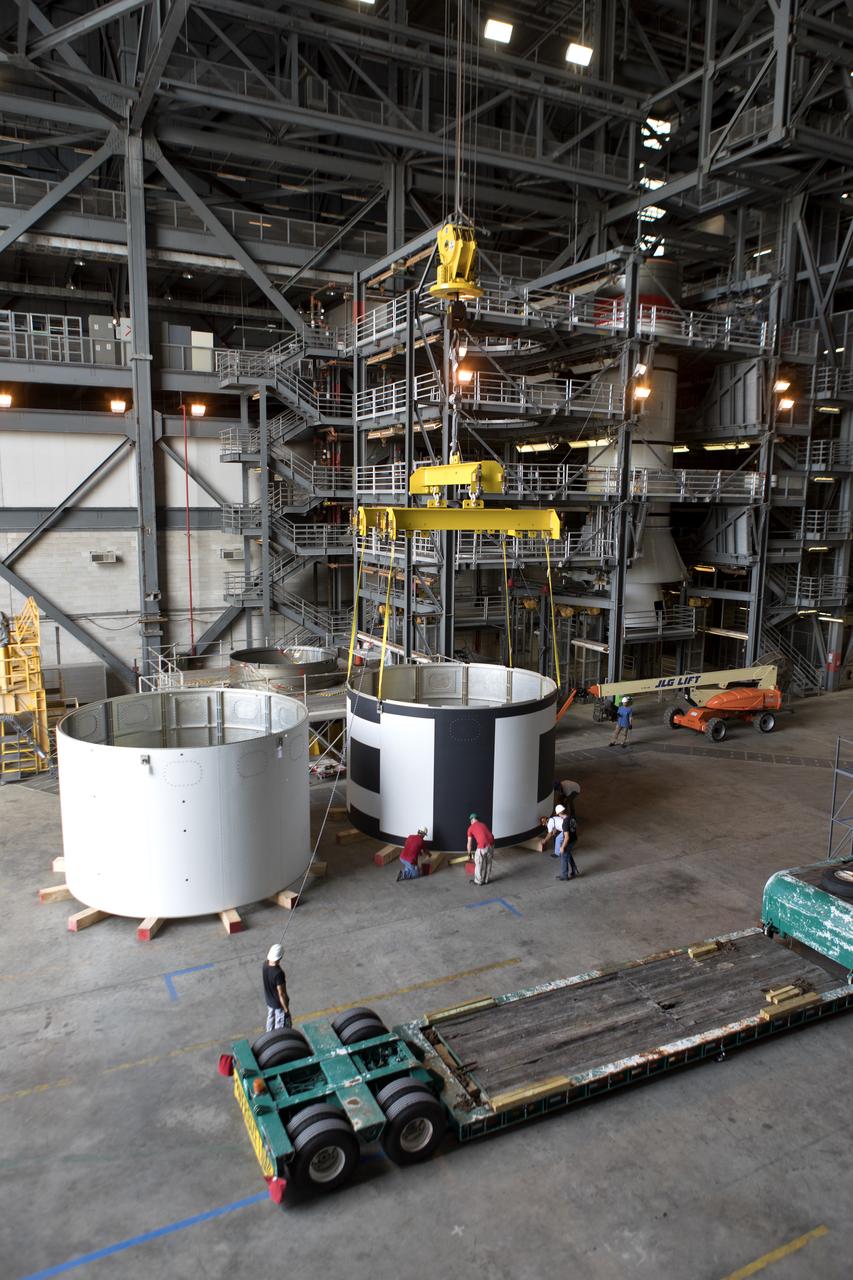 The second of three aeroshells, at right, for Orion's Launch Abort System (LAS) was lifted up from a flatbed truck and secured in High Bay 4 of the Vehicle Assembly Building at NASA's Kennedy Space Center in Florida, on June 26, 2018. The aeroshell was shipped from EMF Inc. on nearby Merritt Island. The aeroshells will be stacked and prepared for a full-stress test of the LAS, called Ascent Abort-2 (AA-2) flight test, scheduled for April 2019. During the test, a booster will launch from Space Launch Complex 46 at Cape Canaveral Air Force Station, carrying a fully functional LAS and a 22,000-pound Orion test vehicle to an altitude of 31,000 feet and traveling at more than 1,000 miles an hour. The test will verify the LAS can steer the crew module and astronauts aboard to safety in the event of an issue with the Space Launch System (SLS) rocket when the spacecraft is under the highest aerodynamic loads it will experience during a rapid climb into space. Orion is being prepared for its first integrated uncrewed flight atop the SLS on Exploration Mission-1.