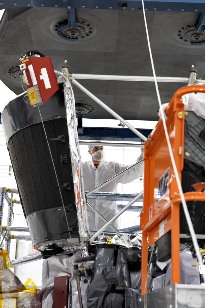 In the Astrotech processing facility in Titusville, Florida, near NASA's Kennedy Space Center, on Wednesday, June 27, 2018, technicians and engineers install the heat shield on NASA's Parker Solar Probe. The Parker Solar Probe will launch on a United Launch Alliance Delta IV Heavy rocket from Space Launch Complex 37 at Cape Canaveral Air Force Station in Florida no earlier than Aug. 4, 2018. The mission will perform the closest-ever observations of a star when it travels through the Sun's atmosphere, called the corona. The probe will rely on measurements and imaging to revolutionize our understanding of the corona and the Sun-Earth connection.