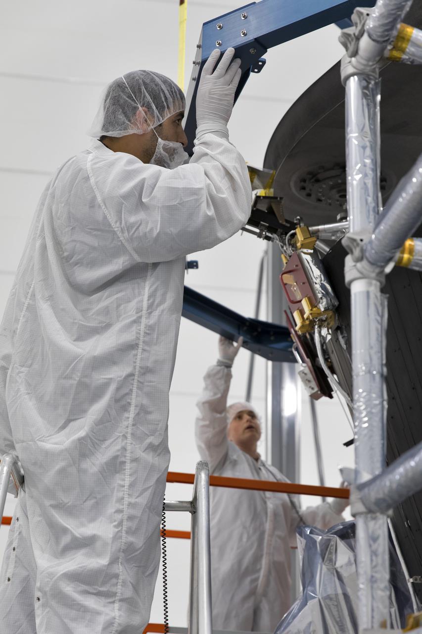 In the Astrotech processing facility in Titusville, Florida, near NASA's Kennedy Space Center, on Wednesday, June 27, 2018, technicians and engineers install the heat shield on NASA's Parker Solar Probe. The Parker Solar Probe will launch on a United Launch Alliance Delta IV Heavy rocket from Space Launch Complex 37 at Cape Canaveral Air Force Station in Florida no earlier than Aug. 4, 2018. The mission will perform the closest-ever observations of a star when it travels through the Sun's atmosphere, called the corona. The probe will rely on measurements and imaging to revolutionize our understanding of the corona and the Sun-Earth connection.