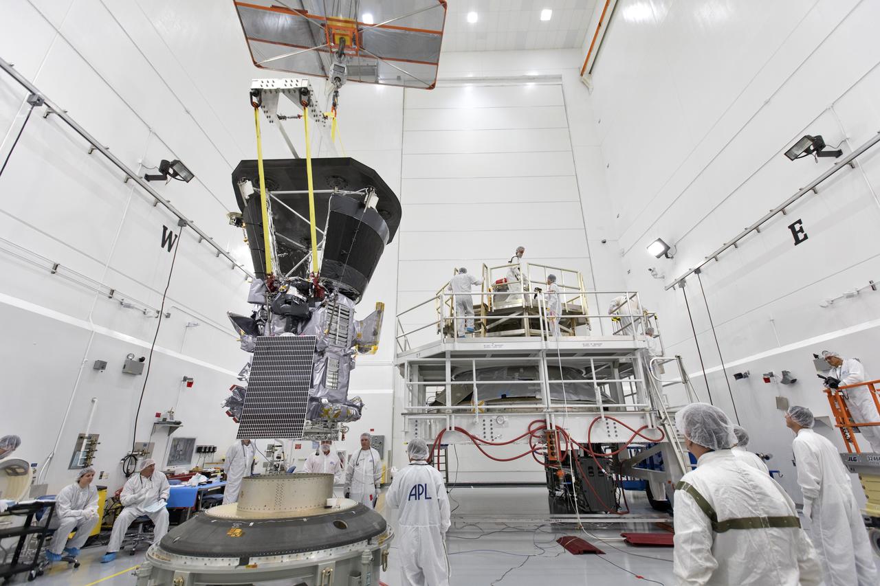 In the Astrotech processing facility in Titusville, Florida, near NASA's Kennedy Space Center, on Wednesday, July 11, 2018, technicians and engineers use a crane to move NASA's Parker Solar Probe into position for mating to its third stage, built and tested by Northrup Grumman in Chandler Arizona. The Parker Solar Probe will launch on a United Launch Alliance Delta IV Heavy rocket from Space Launch Complex 37 at Cape Canaveral Air Force Station in Florida. The mission will perform the closest-ever observations of a star when it travels through the Sun's atmosphere, called the corona. The probe will rely on measurements and imaging to revolutionize our understanding of the corona and the Sun-Earth connection.
