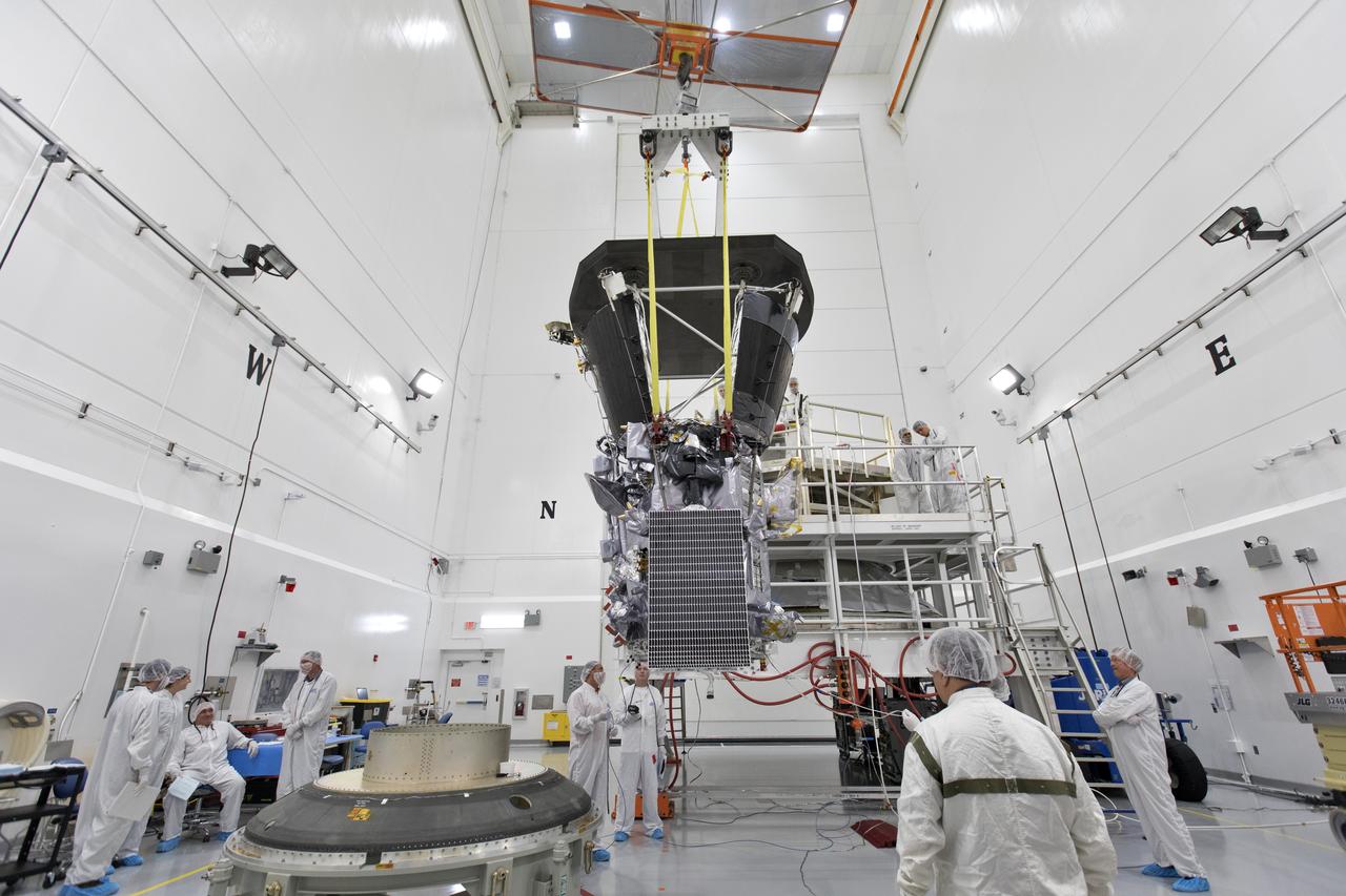 In the Astrotech processing facility in Titusville, Florida, near NASA's Kennedy Space Center, on Wednesday, July 11, 2018, technicians and engineers use a crane to move NASA's Parker Solar Probe into position for mating to its third stage, built and tested by Northrup Grumman in Chandler Arizona. The Parker Solar Probe will launch on a United Launch Alliance Delta IV Heavy rocket from Space Launch Complex 37 at Cape Canaveral Air Force Station in Florida. The mission will perform the closest-ever observations of a star when it travels through the Sun's atmosphere, called the corona. The probe will rely on measurements and imaging to revolutionize our understanding of the corona and the Sun-Earth connection.