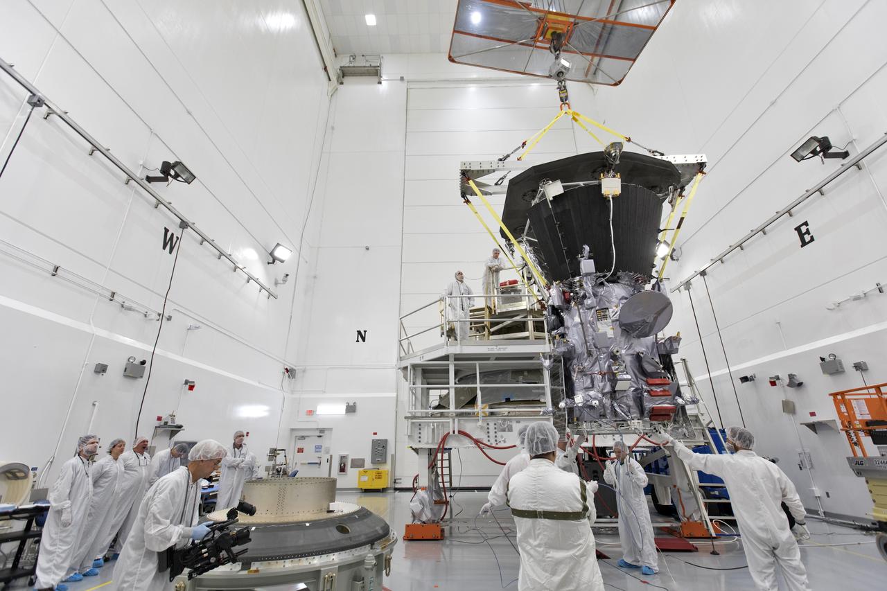 In the Astrotech processing facility in Titusville, Florida, near NASA's Kennedy Space Center, on Wednesday, July 11, 2018, technicians and engineers use a crane to move NASA's Parker Solar Probe into position for mating to its third stage, built and tested by Northrup Grumman in Chandler Arizona. The Parker Solar Probe will launch on a United Launch Alliance Delta IV Heavy rocket from Space Launch Complex 37 at Cape Canaveral Air Force Station in Florida. The mission will perform the closest-ever observations of a star when it travels through the Sun's atmosphere, called the corona. The probe will rely on measurements and imaging to revolutionize our understanding of the corona and the Sun-Earth connection.
