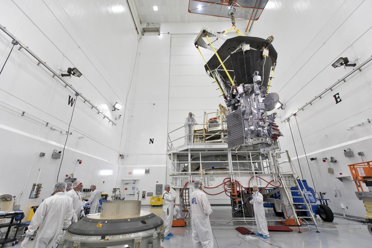 In the Astrotech processing facility in Titusville, Florida, near NASA's Kennedy Space Center, on Wednesday, July 11, 2018, technicians and engineers use a crane to move NASA's Parker Solar Probe into position for mating to its third stage, built and tested by Northrup Grumman in Chandler Arizona. The Parker Solar Probe will launch on a United Launch Alliance Delta IV Heavy rocket from Space Launch Complex 37 at Cape Canaveral Air Force Station in Florida. The mission will perform the closest-ever observations of a star when it travels through the Sun's atmosphere, called the corona. The probe will rely on measurements and imaging to revolutionize our understanding of the corona and the Sun-Earth connection.