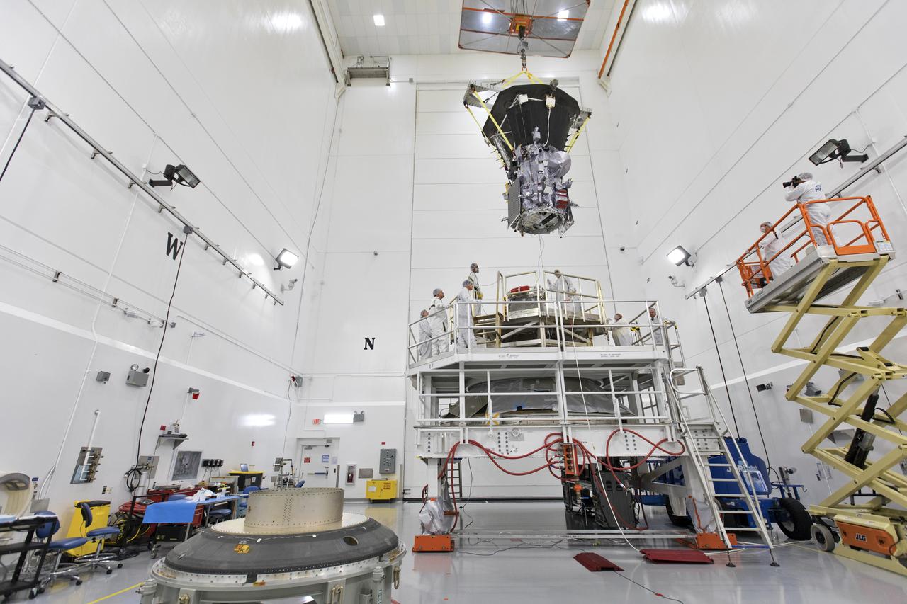 In the Astrotech processing facility in Titusville, Florida, near NASA's Kennedy Space Center, on Wednesday, July 11, 2018, technicians and engineers use a crane to move NASA's Parker Solar Probe into position for mating to its third stage, built and tested by Northrup Grumman in Chandler Arizona. The Parker Solar Probe will launch on a United Launch Alliance Delta IV Heavy rocket from Space Launch Complex 37 at Cape Canaveral Air Force Station in Florida. The mission will perform the closest-ever observations of a star when it travels through the Sun's atmosphere, called the corona. The probe will rely on measurements and imaging to revolutionize our understanding of the corona and the Sun-Earth connection.