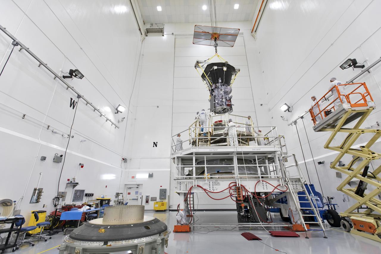 In the Astrotech processing facility in Titusville, Florida, near NASA's Kennedy Space Center, on Wednesday, July 11, 2018, technicians and engineers use a crane to move NASA's Parker Solar Probe into position for mating to its third stage, built and tested by Northrup Grumman in Chandler Arizona. The Parker Solar Probe will launch on a United Launch Alliance Delta IV Heavy rocket from Space Launch Complex 37 at Cape Canaveral Air Force Station in Florida. The mission will perform the closest-ever observations of a star when it travels through the Sun's atmosphere, called the corona. The probe will rely on measurements and imaging to revolutionize our understanding of the corona and the Sun-Earth connection.