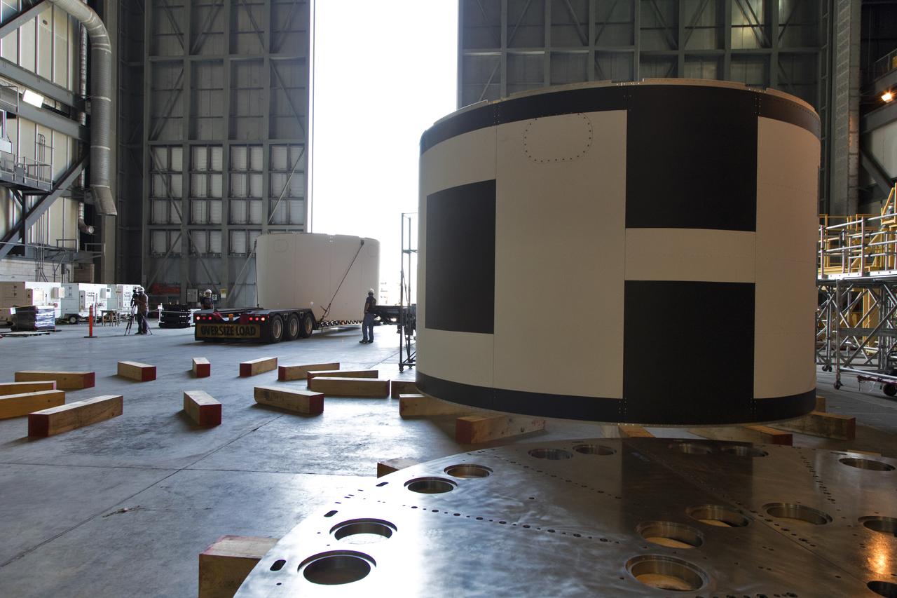 The third and final aeroshell for Orion's Launch Abort System (LAS) arrives by flatbed truck in High Bay 4 of the Vehicle Assembly Building on July 12, 2018, at NASA's Kennedy Space Center in Florida. The aeroshell was shipped from EMF Inc. on nearby Merritt Island. It will be offloaded and secured in the high bay. The aeroshells will be stacked and prepared for a full-stress test of the LAS, called Ascent Abort-2 (AA-2) flight test, scheduled for April 2019. During the test, a booster will launch from Space Launch Complex 46 at Cape Canaveral Air Force Station, carrying a fully functional LAS and a 22,000-pound Orion test vehicle to an altitude of 31,000 feet and traveling at more than 1,000 miles an hour. The test will verify the LAS can steer the crew module and astronauts aboard to safety in the event of an issue with the Space Launch System (SLS) rocket when the spacecraft is under the highest aerodynamic loads it will experience during a rapid climb into space. Orion is being prepared for its first integrated uncrewed flight atop the SLS on Exploration Mission-1.