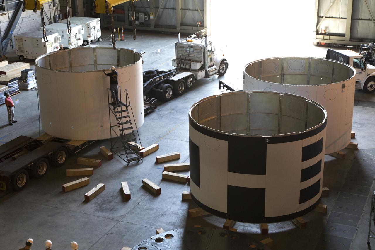 The third and final aeroshell for Orion's Launch Abort System (LAS) is in High Bay 4 of the Vehicle Assembly Building on July 12, 2018, at NASA's Kennedy Space Center in Florida. The aeroshell was shipped from EMF Inc. on nearby Merritt Island. Technicians prepare the aeroshell to be lifted off of the flatbed and transferred to slats. All three aeroshells will be stacked and prepared for a full-stress test of the LAS, called Ascent Abort-2 (AA-2) flight test, scheduled for April 2019. During the test, a booster will launch from Space Launch Complex 46 at Cape Canaveral Air Force Station, carrying a fully functional LAS and a 22,000-pound Orion test vehicle to an altitude of 31,000 feet and traveling at more than 1,000 miles an hour. The test will verify the LAS can steer the crew module and astronauts aboard to safety in the event of an issue with the Space Launch System (SLS) rocket when the spacecraft is under the highest aerodynamic loads it will experience during a rapid climb into space. Orion is being prepared for its first integrated uncrewed flight atop the SLS on Exploration Mission-1.