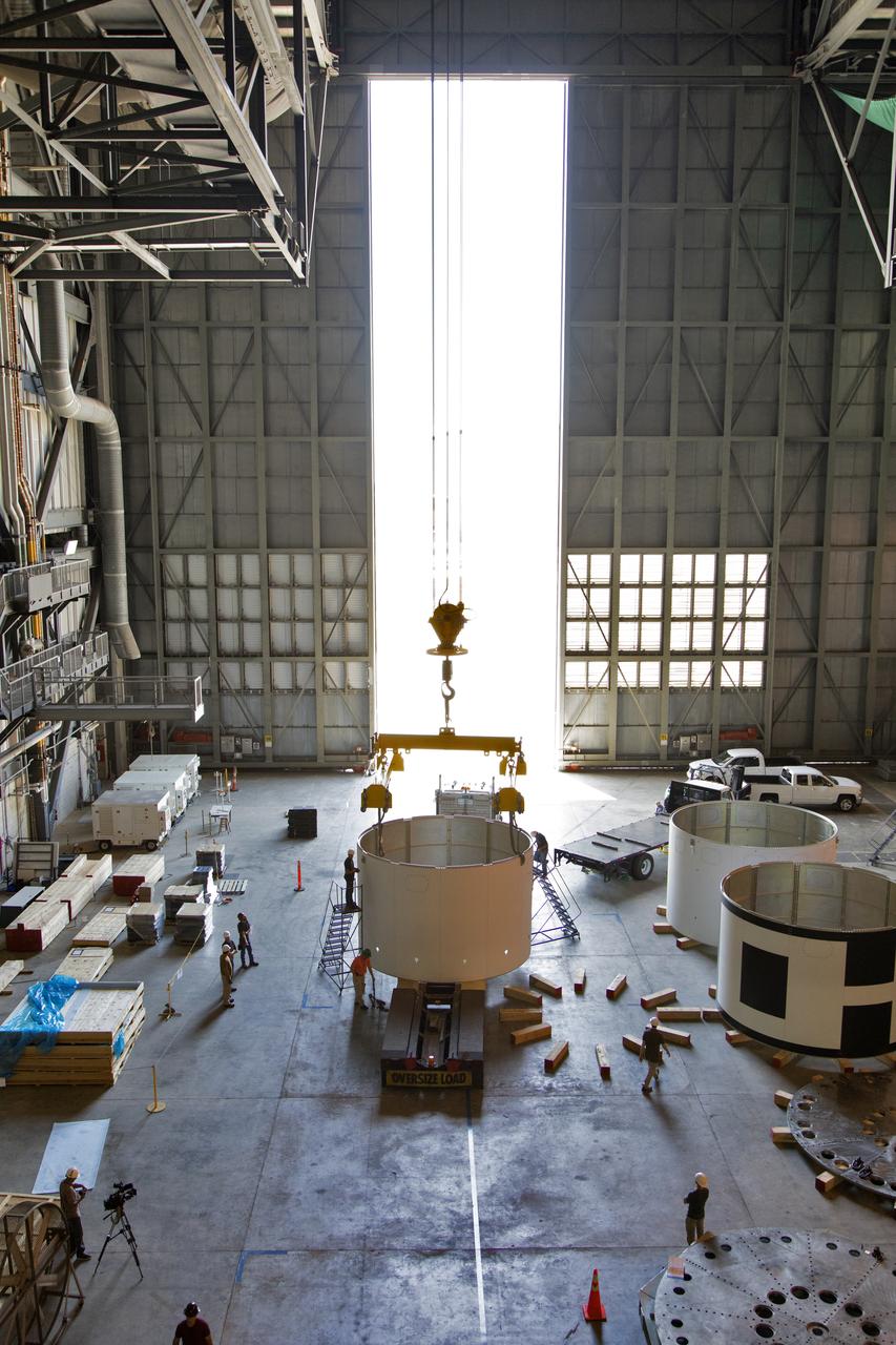 The third and final aeroshell for Orion's Launch Abort System (LAS) is in High Bay 4 of the Vehicle Assembly Building on July 12, 2018, at NASA's Kennedy Space Center in Florida. The aeroshell was shipped from EMF Inc. on nearby Merritt Island. Technicians prepare the aeroshell to be lifted off of the flatbed truck and transferred to slats. All three aeroshells will be stacked and prepared for a full-stress test of the LAS, called Ascent Abort-2 (AA-2) flight test, scheduled for April 2019. During the test, a booster will launch from Space Launch Complex 46 at Cape Canaveral Air Force Station, carrying a fully functional LAS and a 22,000-pound Orion test vehicle to an altitude of 31,000 feet and traveling at more than 1,000 miles an hour. The test will verify the LAS can steer the crew module and astronauts aboard to safety in the event of an issue with the Space Launch System (SLS) rocket when the spacecraft is under the highest aerodynamic loads it will experience during a rapid climb into space. Orion is being prepared for its first integrated uncrewed flight atop the SLS on Exploration Mission-1.