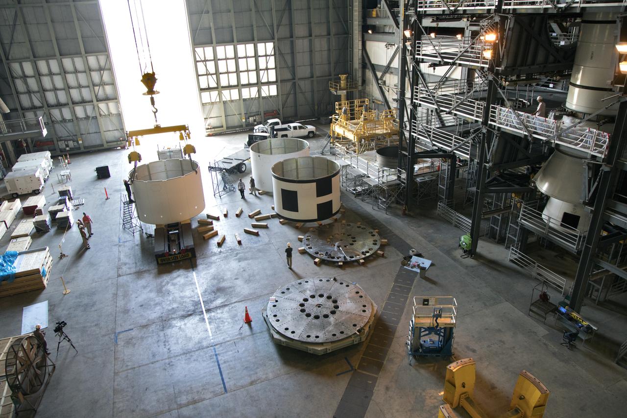 The third and final aeroshell, at left, for Orion's Launch Abort System (LAS) is in High Bay 4 of the Vehicle Assembly Building on July 12, 2018, at NASA's Kennedy Space Center in Florida. The aeroshell was shipped from EMF Inc. on nearby Merritt Island. Technicians prepare the aeroshell to be lifted off of the flatbed truck and transferred to slats. All three aeroshells will be stacked and prepared for a full-stress test of the LAS, called Ascent Abort-2 (AA-2) flight test, scheduled for April 2019. During the test, a booster will launch from Space Launch Complex 46 at Cape Canaveral Air Force Station, carrying a fully functional LAS and a 22,000-pound Orion test vehicle to an altitude of 31,000 feet and traveling at more than 1,000 miles an hour. The test will verify the LAS can steer the crew module and astronauts aboard to safety in the event of an issue with the Space Launch System (SLS) rocket when the spacecraft is under the highest aerodynamic loads it will experience during a rapid climb into space. Orion is being prepared for its first integrated uncrewed flight atop the SLS on Exploration Mission-1.