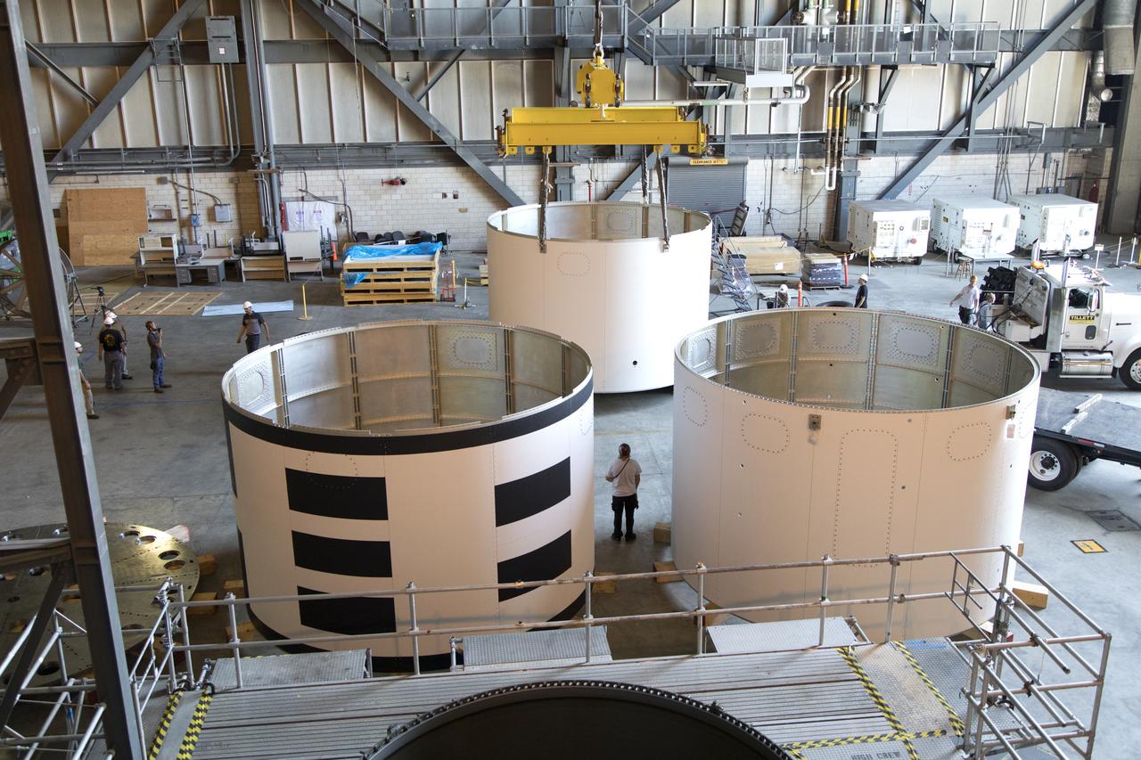 The third and final aeroshell for Orion's Launch Abort System (LAS) is lifted by crane in High Bay 4 of the Vehicle Assembly Building on July 12, 2018, at NASA's Kennedy Space Center in Florida. The aeroshell was shipped from EMF Inc. on nearby Merritt Island. The aeroshell will be lowered onto slats. All three aeroshells will be stacked and prepared for a full-stress test of the LAS, called Ascent Abort-2 (AA-2) flight test, scheduled for April 2019. During the test, a booster will launch from Space Launch Complex 46 at Cape Canaveral Air Force Station, carrying a fully functional LAS and a 22,000-pound Orion test vehicle to an altitude of 31,000 feet and traveling at more than 1,000 miles an hour. The test will verify the LAS can steer the crew module and astronauts aboard to safety in the event of an issue with the Space Launch System (SLS) rocket when the spacecraft is under the highest aerodynamic loads it will experience during a rapid climb into space. Orion is being prepared for its first integrated uncrewed flight atop the SLS on Exploration Mission-1.