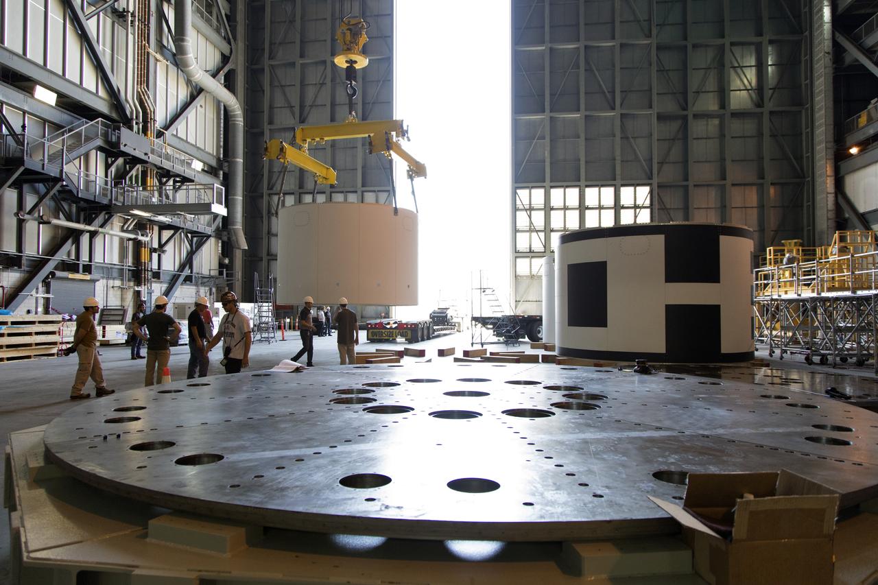 The third and final aeroshell for Orion's Launch Abort System (LAS) is lifted by crane and will be lowered onto slats in High Bay 4 of the Vehicle Assembly Building on July 12, 2018, at NASA's Kennedy Space Center in Florida. The aeroshell was shipped from EMF Inc. on nearby Merritt Island. All three aeroshells will be stacked and prepared for a full-stress test of the LAS, called Ascent Abort-2 (AA-2) flight test, scheduled for April 2019. During the test, a booster will launch from Space Launch Complex 46 at Cape Canaveral Air Force Station, carrying a fully functional LAS and a 22,000-pound Orion test vehicle to an altitude of 31,000 feet and traveling at more than 1,000 miles an hour. The test will verify the LAS can steer the crew module and astronauts aboard to safety in the event of an issue with the Space Launch System (SLS) rocket when the spacecraft is under the highest aerodynamic loads it will experience during a rapid climb into space. Orion is being prepared for its first integrated uncrewed flight atop the SLS on Exploration Mission-1.