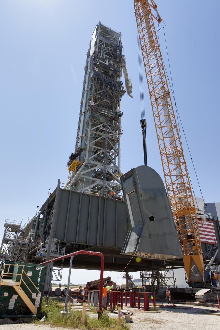 The first of two Tail Service Mast Umbilicals is lifted up for installation on the 0-level deck of the mobile launcher on July 12, at NASA's Kennedy Space Center in Florida. The 35-foot-tall umbilical will connect to NASA's Space Launch System rocket core stage aft section and provide liquid oxygen and electrical cable connections to the core stage engine section to support propellant handling during prelaunch operations. The installation brings Exploration Ground Systems one step closer to supporting prelaunch operations for the agency's SLS rocket and Orion spacecraft on Exploration Mission-1 and deep space destinations.