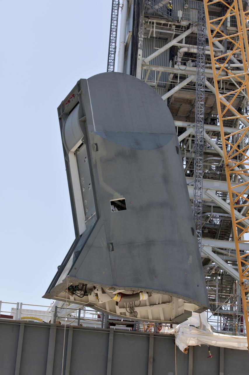 The first of two Tail Service Mast Umbilicals is lifted up for installation on the 0-level deck of the mobile launcher on July 12, at NASA's Kennedy Space Center in Florida. The 35-foot-tall umbilical will connect to NASA's Space Launch System rocket core stage aft section and provide liquid oxygen and electrical cable connections to the core stage engine section to support propellant handling during prelaunch operations. The installation brings Exploration Ground Systems one step closer to supporting prelaunch operations for the agency's SLS rocket and Orion spacecraft on Exploration Mission-1 and deep space destinations.