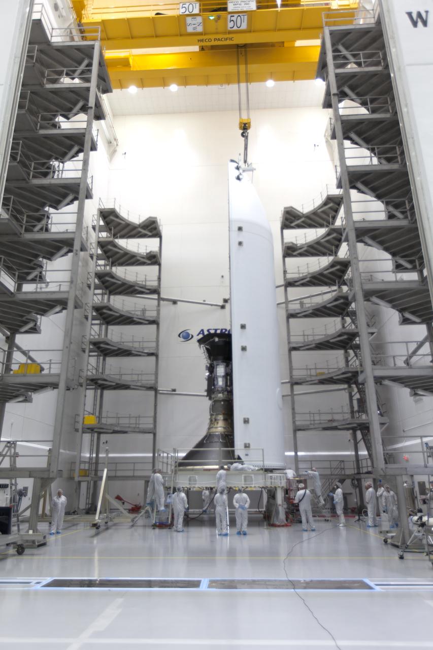 In the Astrotech processing facility in Titusville, Florida, near NASA's Kennedy Space Center, on Monday, July 16, 2018, technicians and engineers encapsulate NASA's Parker Solar Probe in its payload fairing. The spacecraft is mated to its third stage, built and tested by Northrup Grumman in Chandler, Arizona. The Parker Solar Probe will launch on a United Launch Alliance Delta IV Heavy rocket from Space Launch Complex 37 at Cape Canaveral Air Force Station in Florida. The mission will perform the closest-ever observations of a star when it travels through the Sun's atmosphere, called the corona. The probe will rely on measurements and imaging to revolutionize our understanding of the corona and the Sun-Earth connection.