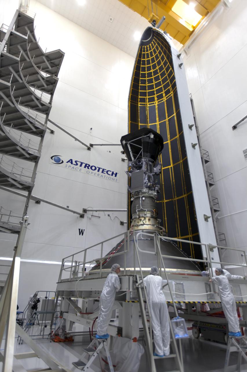 In the Astrotech processing facility in Titusville, Florida, near NASA's Kennedy Space Center, on Monday, July 16, 2018, technicians and engineers encapsulate NASA's Parker Solar Probe in its payload fairing. The spacecraft is mated to its third stage, built and tested by Northrup Grumman in Chandler, Arizona. The Parker Solar Probe will launch on a United Launch Alliance Delta IV Heavy rocket from Space Launch Complex 37 at Cape Canaveral Air Force Station in Florida. The mission will perform the closest-ever observations of a star when it travels through the Sun's atmosphere, called the corona. The probe will rely on measurements and imaging to revolutionize our understanding of the corona and the Sun-Earth connection.
