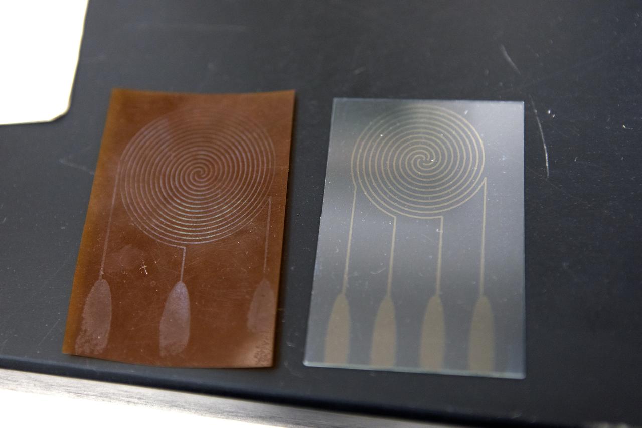 In the Electrostatics and Surface Physics Laboratory at NASA's Kennedy Space Center in Florida, an Electrostatic Dust Shield is seen prior to testing on Thursday, July 19, 2018. Scientists are developing the Electrostatic Dust Shield to help mitigate the problem of dust on equipment, space suits and helmet visors of astronauts exploring the Moon or Mars. The device is slated for analysis aboard International Space Station in the spring of 2019 to verify the effects of the space environment.