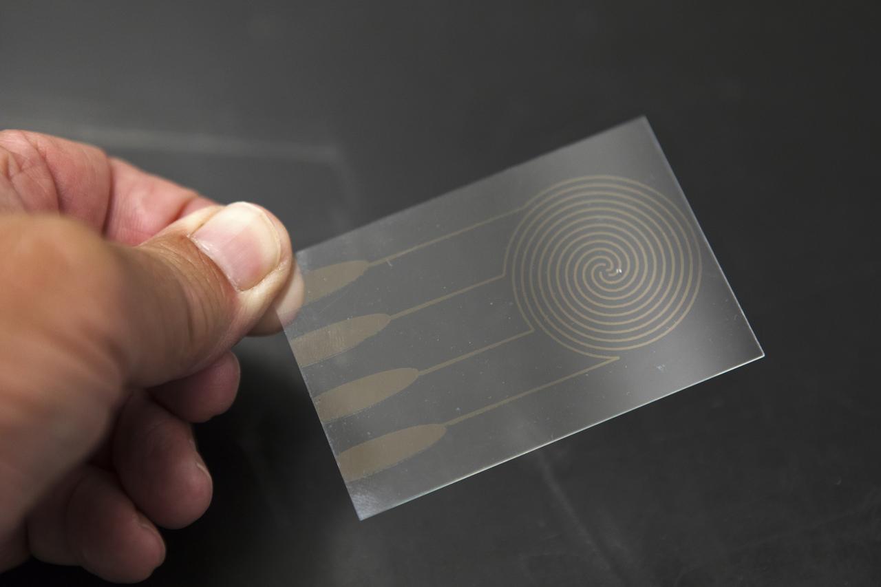 In the Electrostatics and Surface Physics Laboratory at NASA's Kennedy Space Center in Florida, an Electrostatic Dust Shield is seen prior to testing on Thursday, July 19, 2018. Scientists are developing the Electrostatic Dust Shield to help mitigate the problem of dust on equipment, astronauts' space suits and helmet visors of astronauts exploring the Moon or Mars. The device is slated for analysis aboard International Space Station in the spring of 2019 to verify the effects of the space environment.