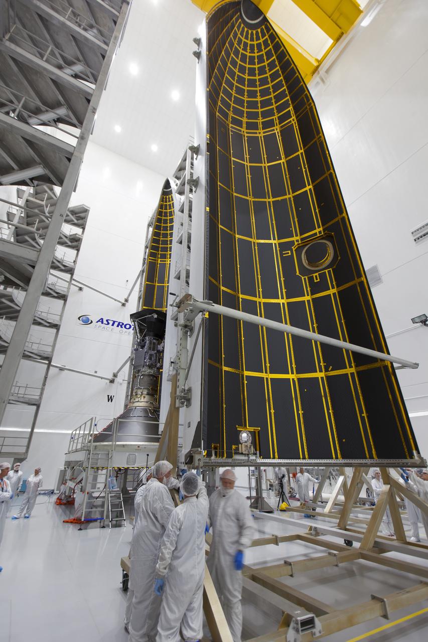 In the Astrotech processing facility in Titusville, Florida, near NASA's Kennedy Space Center, on Thursday, July 19, 2018, technicians and engineers encapsulate NASA's Parker Solar Probe in its payload fairing. The spacecraft is mated to its third stage, built and tested by Northrup Grumman in Chandler, Arizona. The Parker Solar Probe will launch on a United Launch Alliance Delta IV Heavy rocket from Space Launch Complex 37 at Cape Canaveral Air Force Station in Florida. The mission will perform the closest-ever observations of a star when it travels through the Sun's atmosphere, called the corona. The probe will rely on measurements and imaging to revolutionize our understanding of the corona and the Sun-Earth connection.