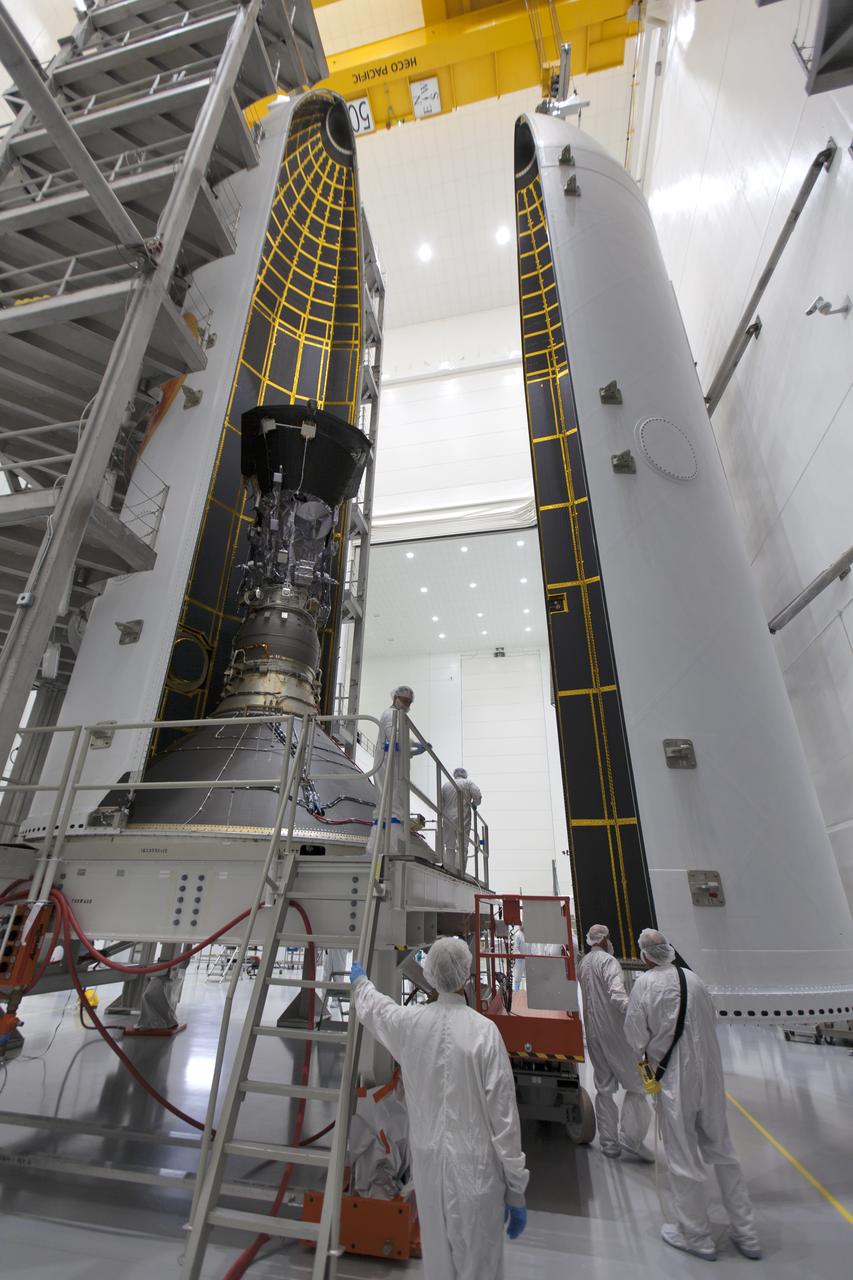 In the Astrotech processing facility in Titusville, Florida, near NASA's Kennedy Space Center, on Thursday, July 19, 2018, technicians and engineers encapsulate NASA's Parker Solar Probe in its payload fairing. The spacecraft is mated to its third stage, built and tested by Northrup Grumman in Chandler, Arizona. The Parker Solar Probe will launch on a United Launch Alliance Delta IV Heavy rocket from Space Launch Complex 37 at Cape Canaveral Air Force Station in Florida. The mission will perform the closest-ever observations of a star when it travels through the Sun's atmosphere, called the corona. The probe will rely on measurements and imaging to revolutionize our understanding of the corona and the Sun-Earth connection.