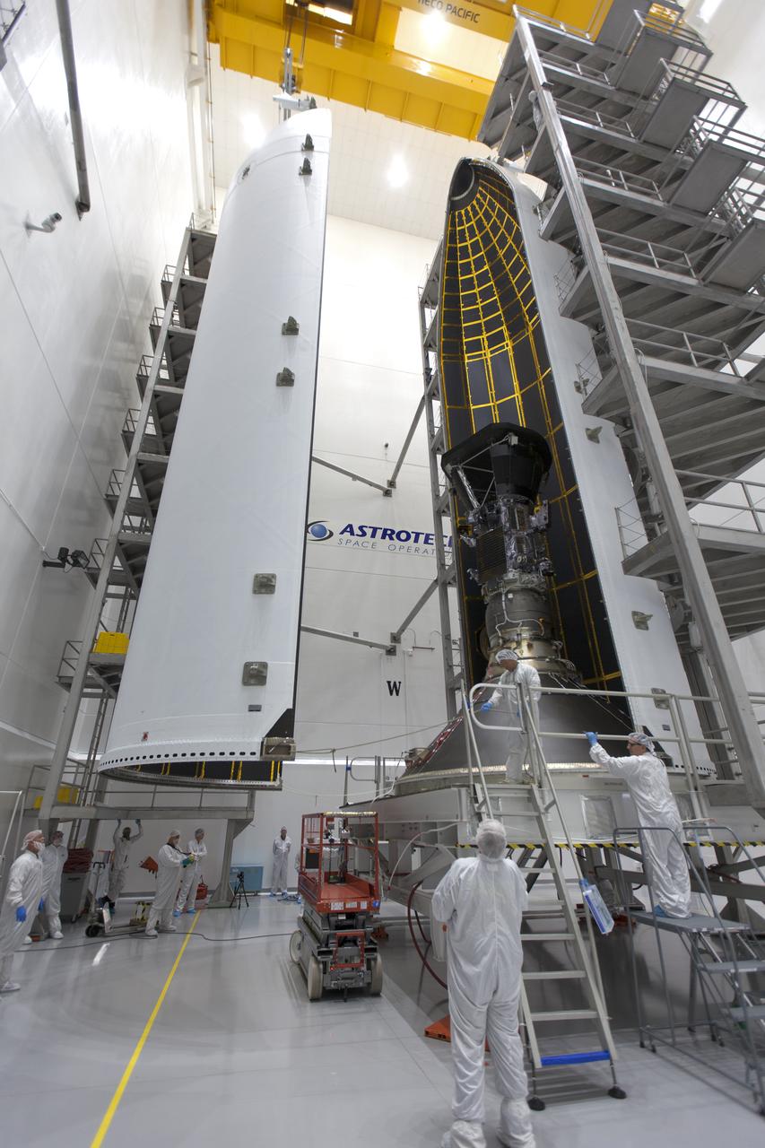 In the Astrotech processing facility in Titusville, Florida, near NASA's Kennedy Space Center, on Thursday, July 19, 2018, technicians and engineers encapsulate NASA's Parker Solar Probe in its payload fairing. The spacecraft is mated to its third stage, built and tested by Northrup Grumman in Chandler, Arizona. The Parker Solar Probe will launch on a United Launch Alliance Delta IV Heavy rocket from Space Launch Complex 37 at Cape Canaveral Air Force Station in Florida. The mission will perform the closest-ever observations of a star when it travels through the Sun's atmosphere, called the corona. The probe will rely on measurements and imaging to revolutionize our understanding of the corona and the Sun-Earth connection.