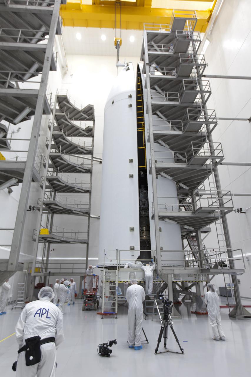In the Astrotech processing facility in Titusville, Florida, near NASA's Kennedy Space Center, on Thursday, July 19, 2018, technicians and engineers encapsulate NASA's Parker Solar Probe in its payload fairing. The spacecraft is mated to its third stage, built and tested by Northrup Grumman in Chandler Arizona. The Parker Solar Probe will launch on a United Launch Alliance Delta IV Heavy rocket from Space Launch Complex 37 at Cape Canaveral Air Force Station in Florida. The mission will perform the closest-ever observations of a star when it travels through the Sun's atmosphere, called the corona. The probe will rely on measurements and imaging to revolutionize our understanding of the corona and the Sun-Earth connection.