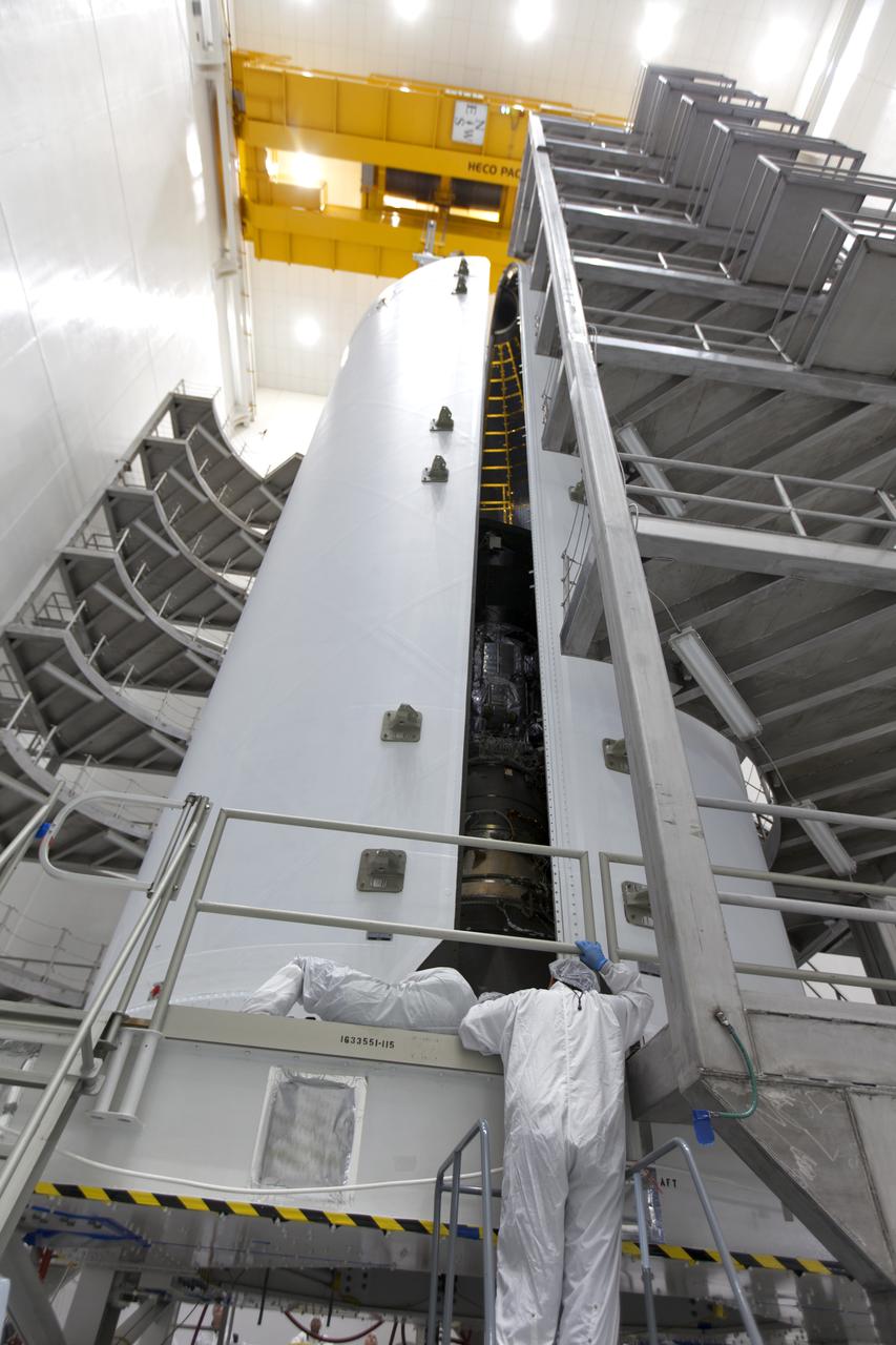 In the Astrotech processing facility in Titusville, Florida, near NASA's Kennedy Space Center, on Thursday, July 19, 2018, technicians and engineers encapsulate NASA's Parker Solar Probe in its payload fairing. The spacecraft is mated to its third stage, built and tested by Northrup Grumman in Chandler, Arizona. The Parker Solar Probe will launch on a United Launch Alliance Delta IV Heavy rocket from Space Launch Complex 37 at Cape Canaveral Air Force Station in Florida. The mission will perform the closest-ever observations of a star when it travels through the Sun's atmosphere, called the corona. The probe will rely on measurements and imaging to revolutionize our understanding of the corona and the Sun-Earth connection.
