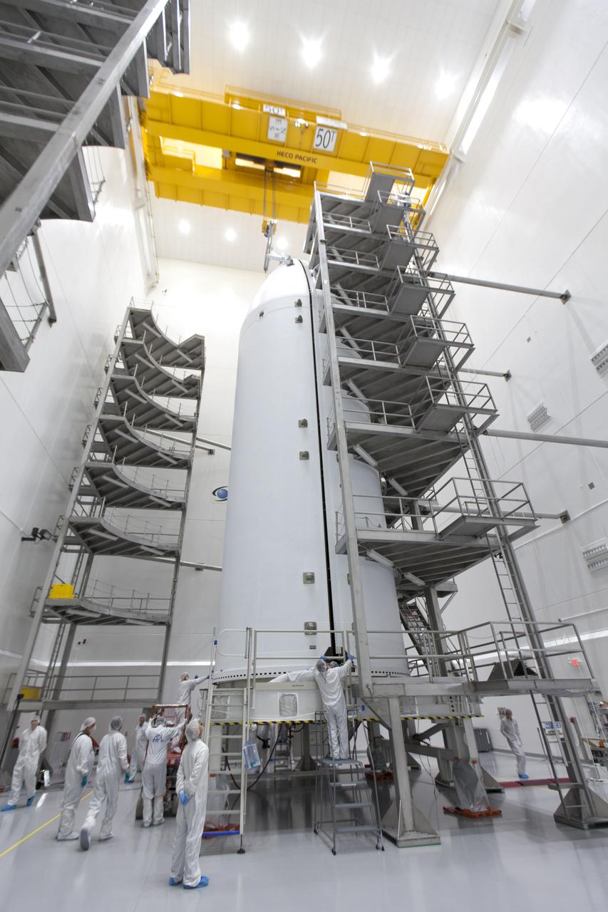 In the Astrotech processing facility in Titusville, Florida, near NASA's Kennedy Space Center, on Thursday, July 19, 2018, technicians and engineers have encapsulated NASA's Parker Solar Probe in its payload fairing. The spacecraft is mated to its third stage, built and tested by Northrup Grumman in Chandler, Arizona. The Parker Solar Probe will launch on a United Launch Alliance Delta IV Heavy rocket from Space Launch Complex 37 at Cape Canaveral Air Force Station in Florida. The mission will perform the closest-ever observations of a star when it travels through the Sun's atmosphere, called the corona. The probe will rely on measurements and imaging to revolutionize our understanding of the corona and the Sun-Earth connection.