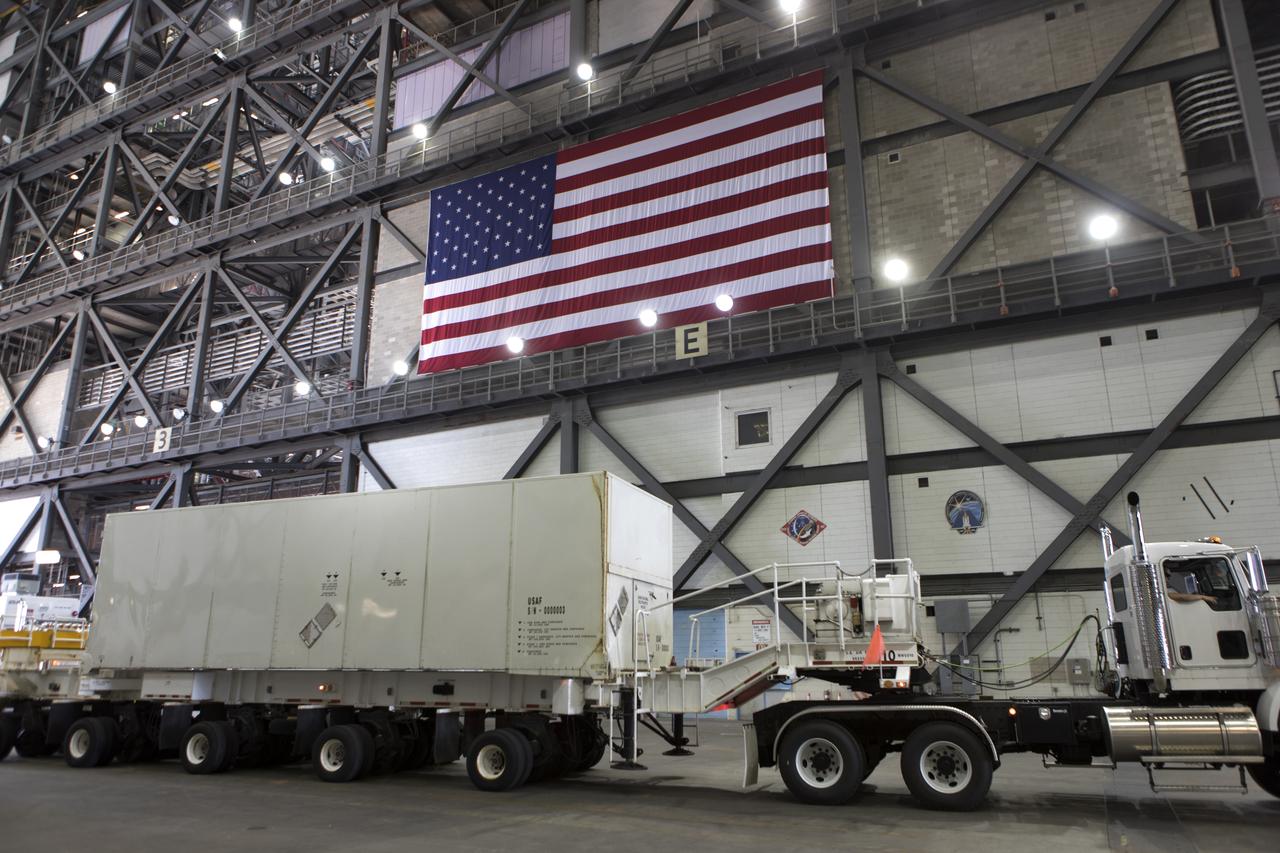 Secured on a flatbed transporter in its shipping container, the ground test motor for Orion's Launch Abort System (LAS) will be moved from the transfer aisle of the Vehicle Assembly Building to the Rotation, Processing and Surge Facility (RPSF) on July 20, 2018, at NASA's Kennedy Space Center in Florida. In the RPSF the motor will be inspected and prepared for transport to Space Launch Complex 46 (SLC-46) at Cape Canaveral Air Force Station for mechanical fit testing. This inert motor will not be used for flight, but will be used to certify flight hardware assembly in preparation for a full-stress test of the LAS, called Ascent Abort-2 (AA-2) flight test, scheduled for April 2019. During the test, the booster will launch from SLC 46, carrying a fully functional LAS and a 22,000-pound Orion test vehicle to an altitude of 31,000 feet and traveling at more than 1,000 miles an hour. The test will verify the LAS can steer the crew module and astronauts aboard to safety in the event of an issue with the Space Launch System (SLS) rocket when the spacecraft is under the highest aerodynamic loads it will experience during a rapid climb into space. NASA's Orion and Exploration Ground Systems programs and their contractors from Jacob's and Northrup Grumman in conjunction with the Air Force Space and Missile Center's Launch Operations branch SMC/LEXO, are performing the pathfinding exercises and flight operations for AA-2.