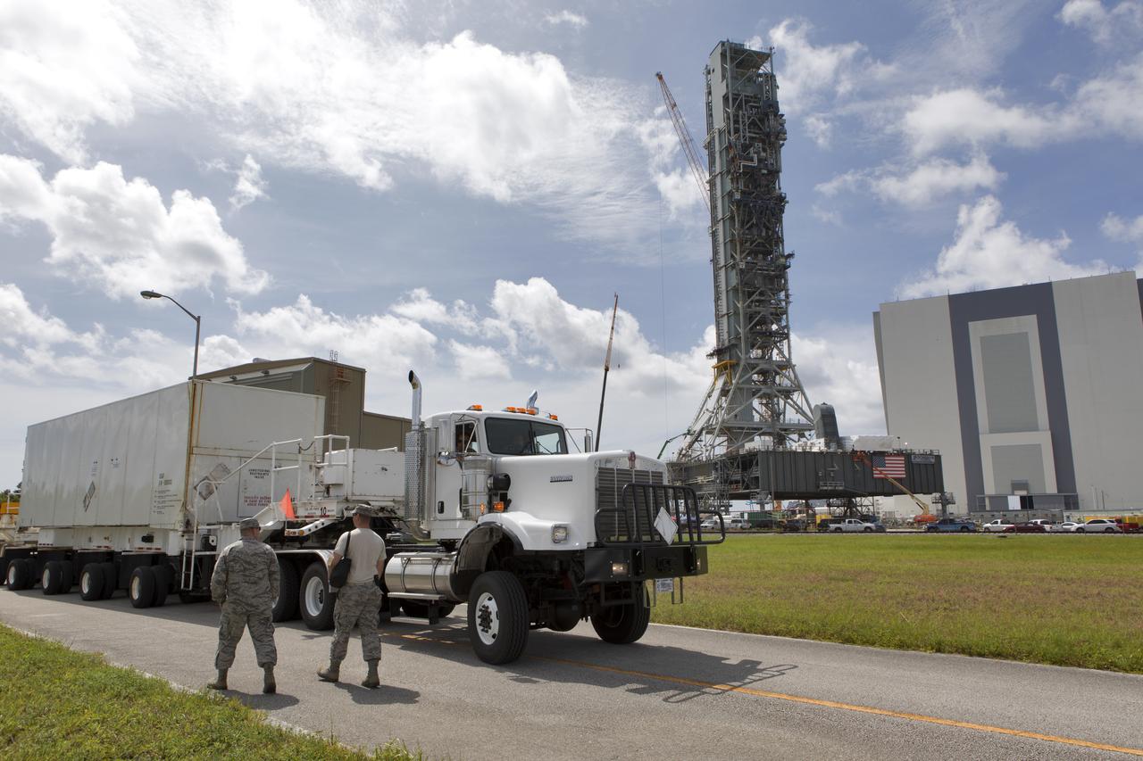 Secured on a flatbed transporter in its shipping container, the ground test motor for Orion's Launch Abort System (LAS) is moved to the Rotation, Processing and Surge Facility (RPSF) on July 20, 2018, at NASA's Kennedy Space Center in Florida. In the RPSF the motor will be inspected and prepared for transport to Space Launch Complex 46 (SLC-46) at Cape Canaveral Air Force Station for mechanical fit testing. This inert motor will not be used for flight, but will be used to certify flight hardware assembly in preparation for a full-stress test of the LAS, called Ascent Abort-2 (AA-2) flight test, scheduled for April 2019. During the test, the booster will launch from SLC 46, carrying a fully functional LAS and a 22,000-pound Orion test vehicle to an altitude of 31,000 feet and traveling at more than 1,000 miles an hour. The test will verify the LAS can steer the crew module and astronauts aboard to safety in the event of an issue with the Space Launch System (SLS) rocket when the spacecraft is under the highest aerodynamic loads it will experience during a rapid climb into space. NASA's Orion and Exploration Ground Systems programs and their contractors from Jacob's and Northrup Grumman in conjunction with the Air Force Space and Missile Center's Launch Operations branch SMC/LEXO, are performing the pathfinding exercises and flight operations for AA-2.