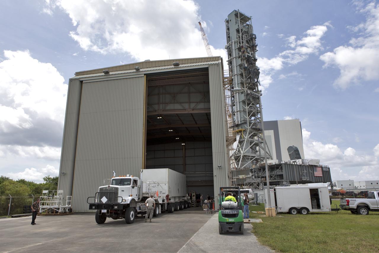 Secured on a flatbed transporter in its shipping container, the ground test motor for Orion's Launch Abort System (LAS) arrives at the Rotation, Processing and Surge Facility (RPSF) on July 20, 2018, at NASA's Kennedy Space Center in Florida. In the RPSF the motor will be inspected and prepared for transport to Space Launch Complex 46 (SLC-46) at Cape Canaveral Air Force Station for mechanical fit testing. This inert motor will not be used for flight, but will be used to certify flight hardware assembly in preparation for a full-stress test of the LAS, called Ascent Abort-2 (AA-2) flight test, scheduled for April 2019. During the test, the booster will launch from SLC 46, carrying a fully functional LAS and a 22,000-pound Orion test vehicle to an altitude of 31,000 feet and traveling at more than 1,000 miles an hour. The test will verify the LAS can steer the crew module and astronauts aboard to safety in the event of an issue with the Space Launch System (SLS) rocket when the spacecraft is under the highest aerodynamic loads it will experience during a rapid climb into space. Orion is being prepared for its first integrated uncrewed flight atop the SLS on Exploration Mission-1. NASA's Orion and Exploration Ground Systems programs and their contractors from Jacob's and Northrup Grumman in conjunction with the Air Force Space and Missile Center's Launch Operations branch SMC/LEXO, are performing the pathfinding exercises and flight operations for AA-2.
