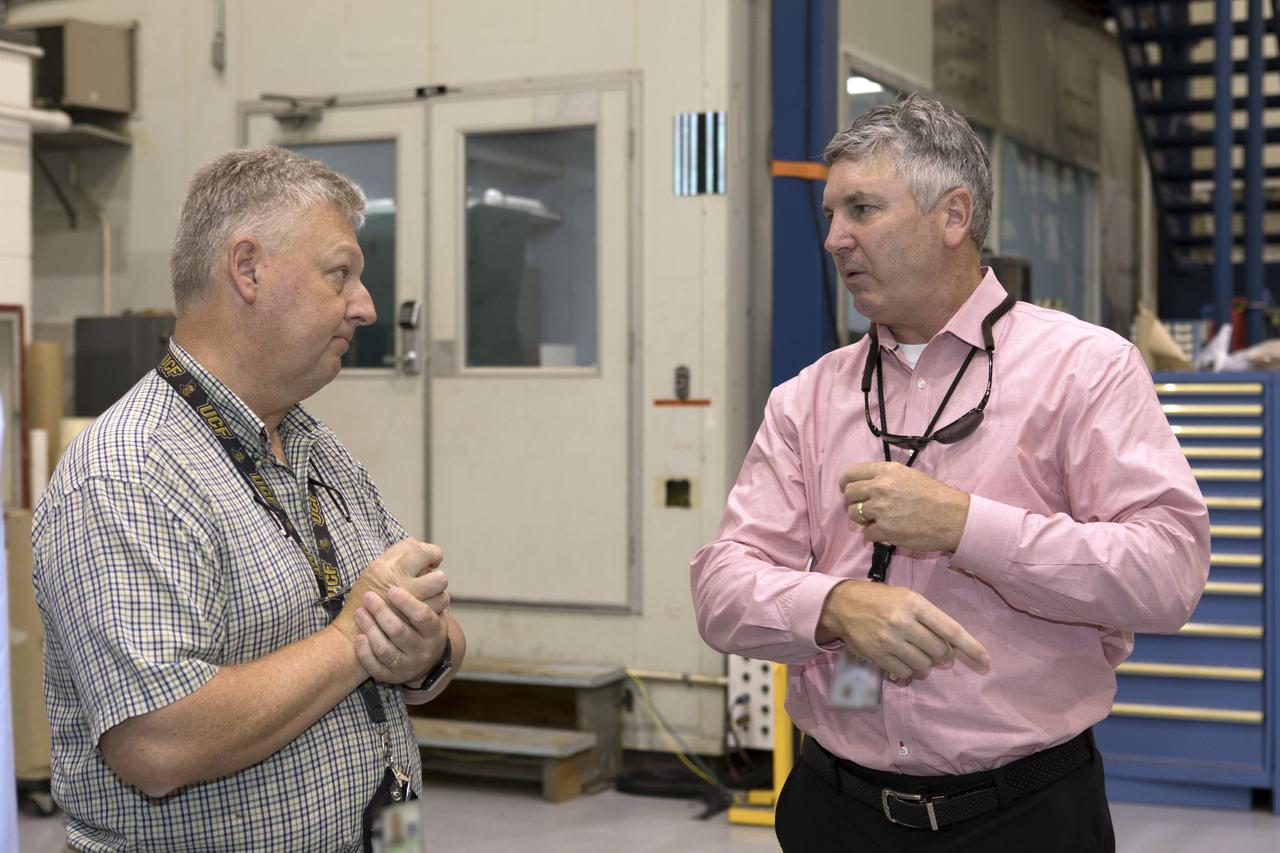 The team that tested the umbilical lines and accessories that will connect from the mobile launcher to NASA's Space Launch System rocket and Orion spacecraft for Exploration Mission-1 hold a banner signing event July 24, 2018, to mark completion of testing at the Launch Equipment Test Facility (LETF) at NASA's Kennedy Space Center in Florida. Attending the event is Scott Colloredo, at right, deputy director of Engineering. A total of 21 umbilicals and launch accessories were tested on various simulators at the LETF before they were transferred to the mobile launcher for installation.