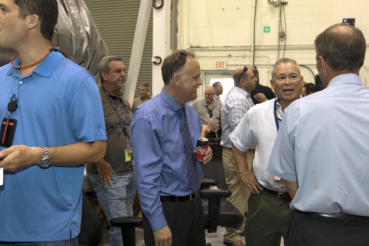 The team that tested the umbilical lines and accessories that will connect from the mobile launcher to NASA's Space Launch System rocket and Orion spacecraft for Exploration Mission-1 hold a banner signing event July 24, 2018, to mark completion of testing at the Launch Equipment Test Facility (LETF) at NASA's Kennedy Space Center in Florida. Attending the event is Shawn Quinn, center, director of Engineering. A total of 21 umbilicals and launch accessories were tested on various simulators at the LETF before they were transferred to the mobile launcher for installation.