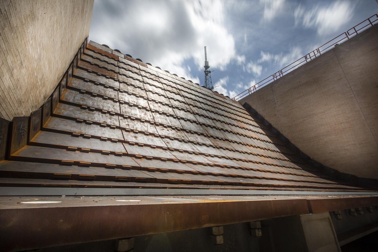 A close-up view of the flame trench and flame deflector at Launch Pad 39B at NASA's Kennedy Space Center in Florida on July 26, 2018. The launch pad has undergone upgrades and modifications to accommodate NASA's Space Launch System and Orion spacecraft for Exploration Mission-1 and other deep space missions. New heat-resistant bricks have been installed on the walls and a new flame deflector is in place. The clean pad concept is designed to support NASA and commercial launch providers at the multi-user spaceport. 