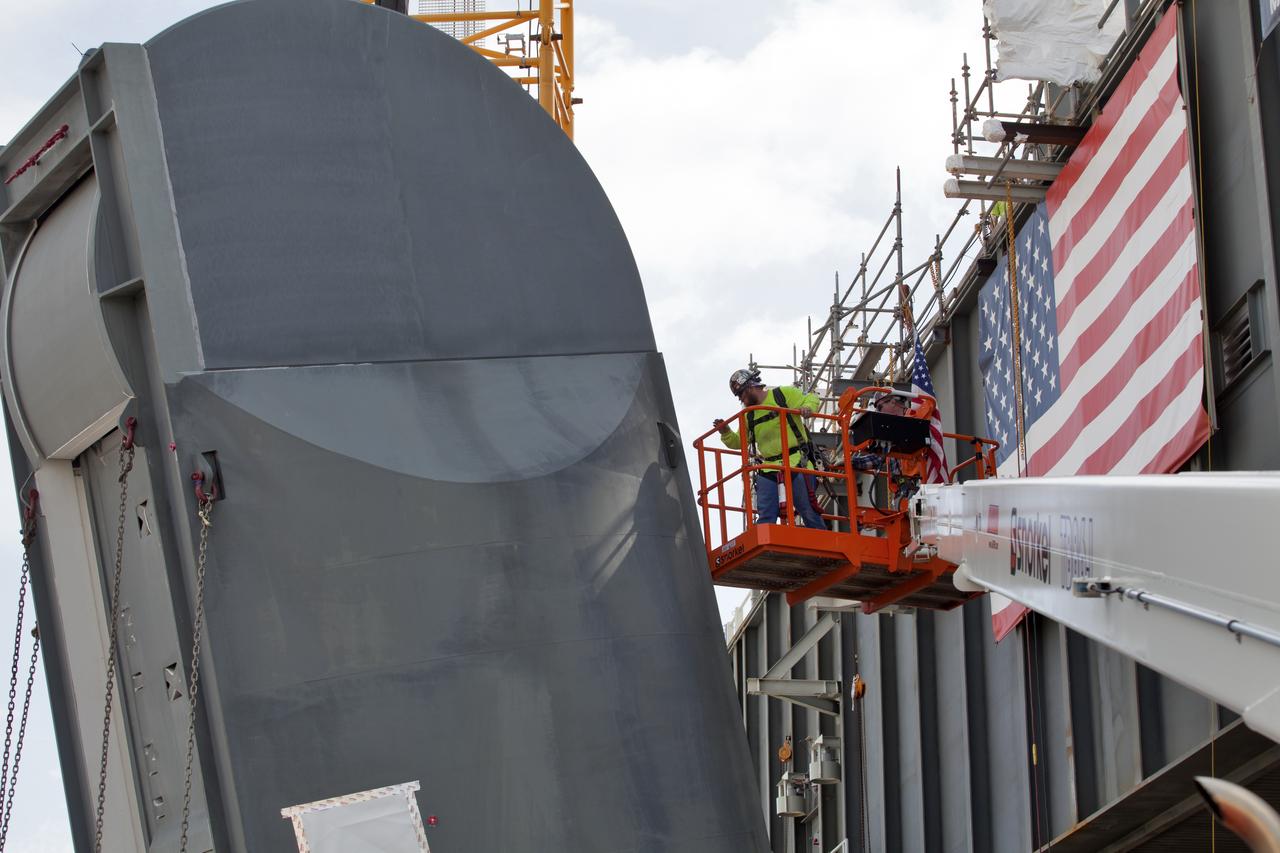 Preparations are underway to install the second of two Tail Service Mast Umbilicals on the 0-level deck of the mobile launcher on July 27, at NASA's Kennedy Space Center in Florida. The 35-foot-tall umbilical will connect to NASA's Space Launch System (SLS) rocket core stage aft section and provide liquid hydrogen and electrical cable connections to the core stage engine section to support propellant handling during prelaunch operations. The installation brings Exploration Ground Systems one step closer to supporting prelaunch operations for the agency's SLS rocket and Orion spacecraft on Exploration Mission-1 and deep space destinations.